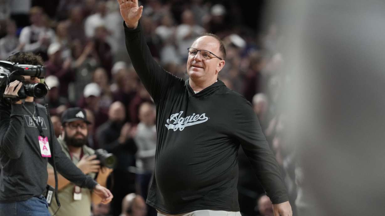 FILE - Texas A&M head football coach Mike Elko waves to the crowd at Reed arena during an NCAA college basketball game between Texas A&M and Kentucky on Saturday, Jan. 13, 2024, in College Station, Texas. The first full week for the upcoming college football season will feature a Saturday tripleheader on ABC, including Texas A&M hosting Notre Dame. ESPN announced its major matchups for Week 0 and Week 1 on Tuesday as part of its presentation to advertisers in New York. The Aug. 31 matchup marks Mike Elko’s first game as Texas A&M’s head coach.
