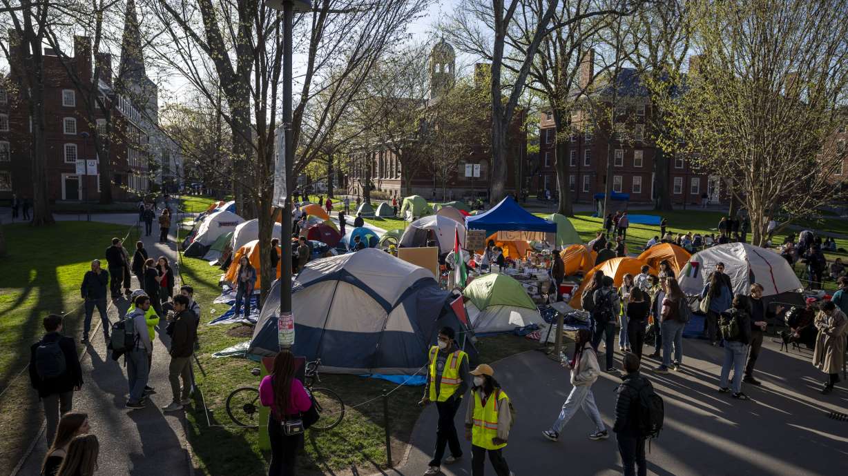 Students protesting against the war in Gaza, and passersby, at an encampment at Harvard University in Cambridge, Mass., on April 25. Participants announced they were voluntarily ending their occupation of Harvard Yard.