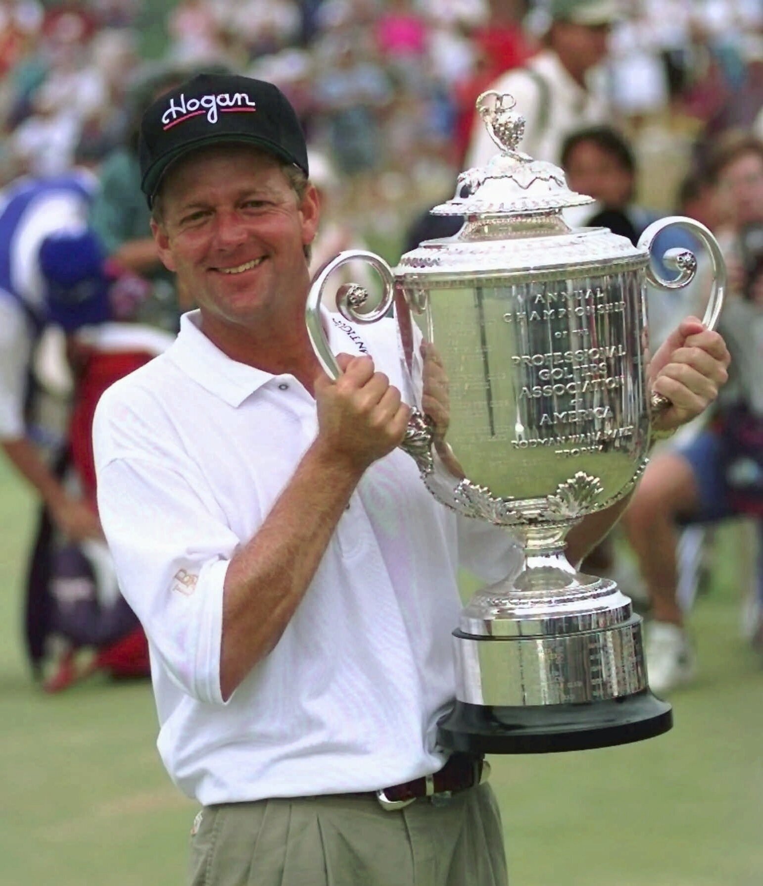 FILE - Mark Brooks holds the Wannamaker trophy on the 18th green of Valhalla Golf Club after beating Kenny Perry in a one-hole playoff to win the PGA Championship on Sunday afternoon, Aug. 11, 1996, in Louisville, Ky. Valhalla hosts its fourth major championship on May 16-19, 2024.