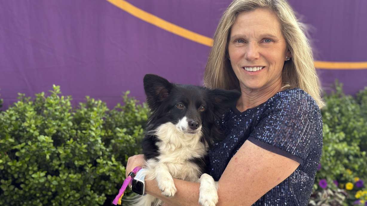 Cynthia Hornor poses with Nimble, the first mixed-breed dog ever to win the Westminster Kennel Club dog show's agility competition, on the show grounds at the USTA Billie Jean King National Tennis Center in New York, Monday, May 13, 2024.