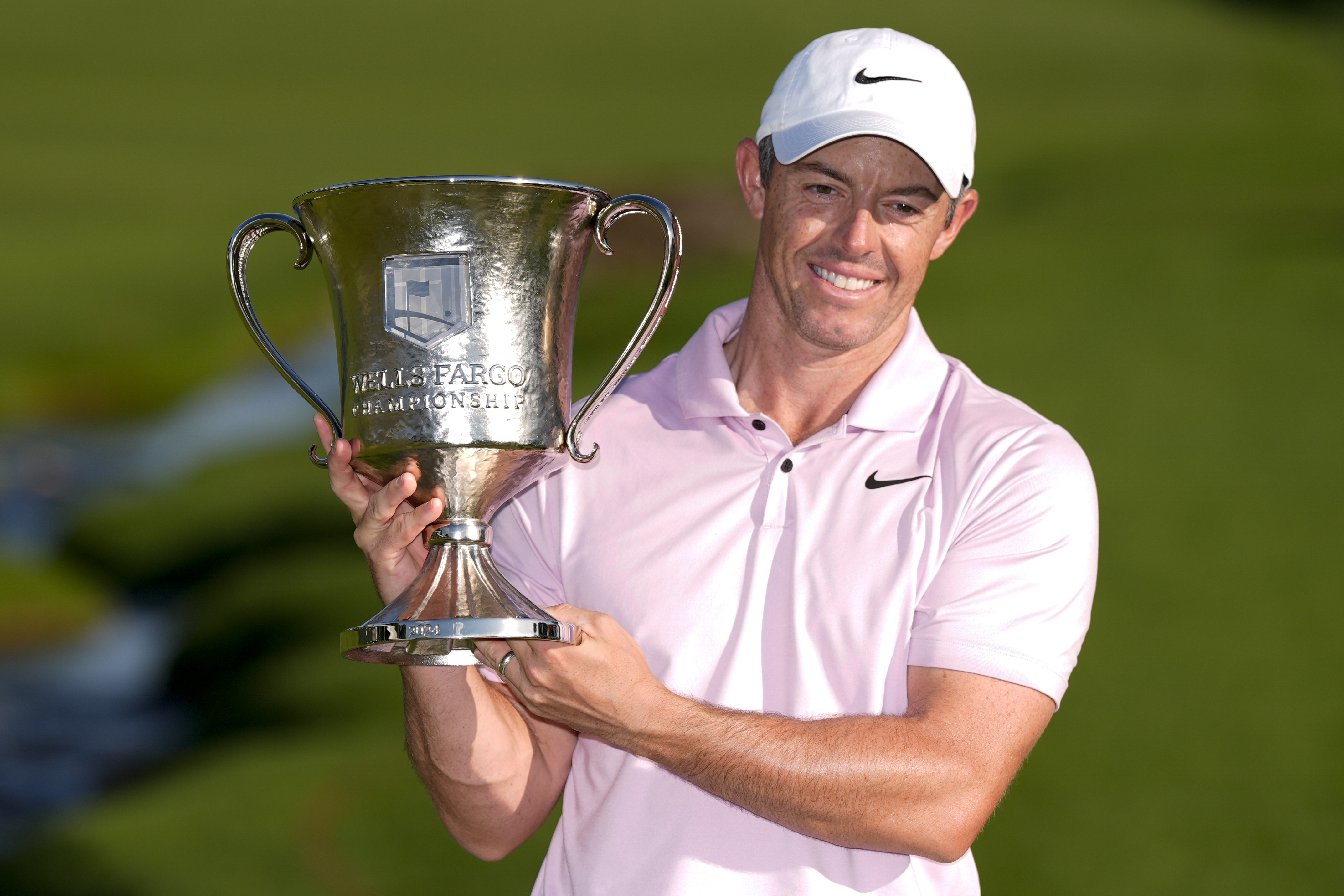 Rory McIlroy, of Northern Ireland, holds the trophy after winning the Wells Fargo Championship golf tournament at the Quail Hollow Club Sunday, May 12, 2024, in Charlotte, N.C. 