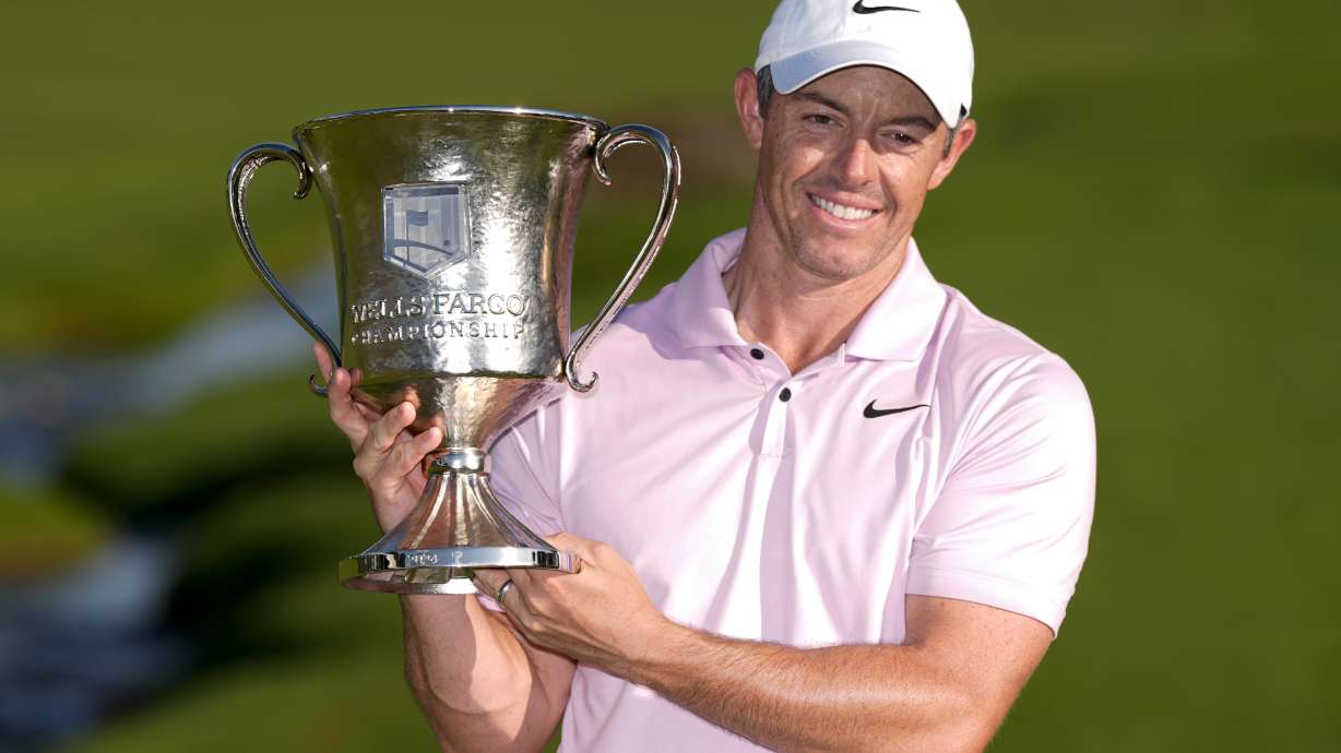 Rory McIlroy, of Northern Ireland, holds the trophy after winning the Wells Fargo Championship golf tournament at the Quail Hollow Club Sunday, May 12, 2024, in Charlotte, N.C.