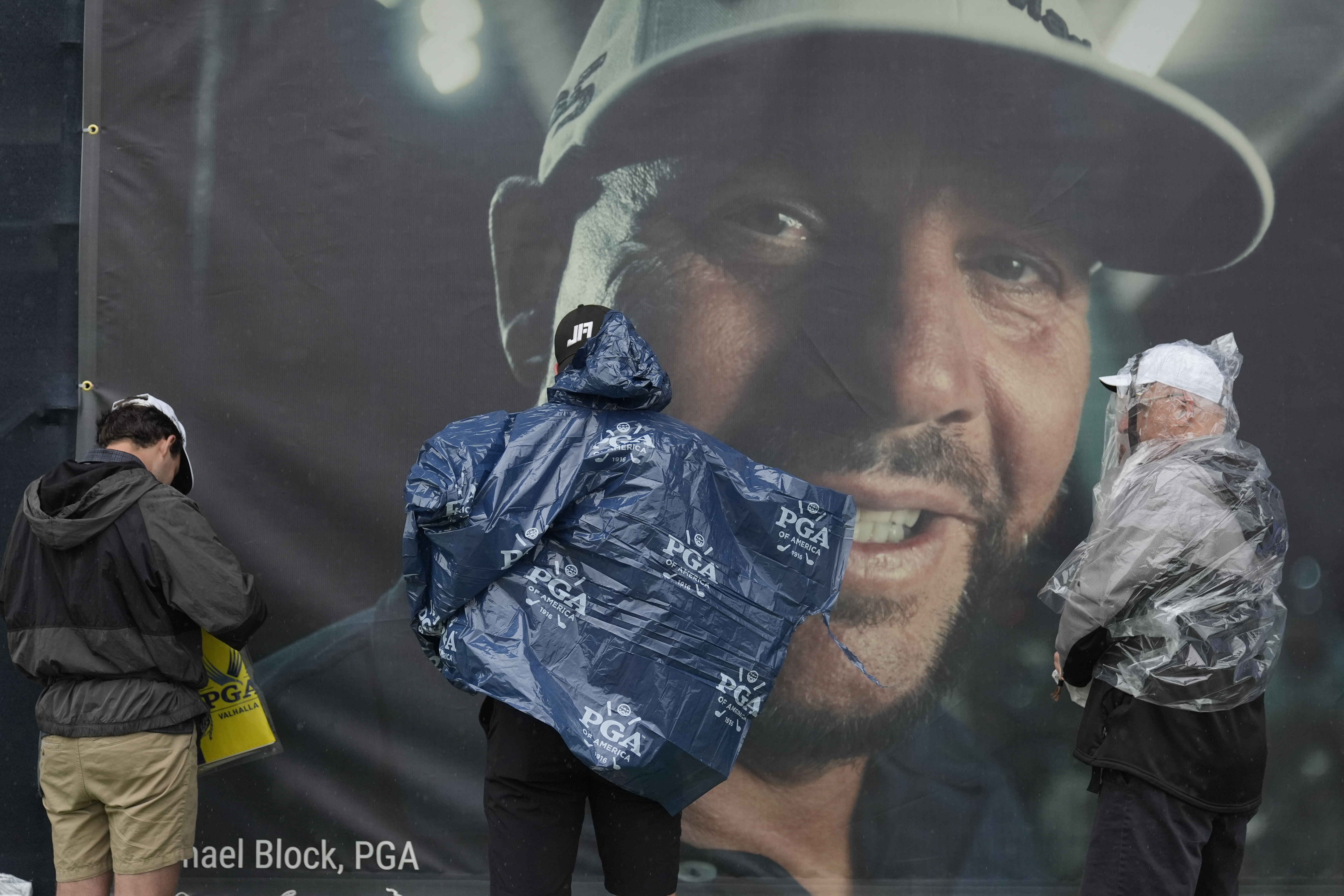 Fans leaves the course past a banner of club pro Michael Block after weather delay during a practice round for the PGA Championship golf tournament at the Valhalla Golf Club, Tuesday, May 14, 2024, in Louisville, Ky. 