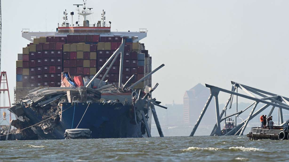 A section of the Francis Scott Key Bridge rests in the water next to the Dali container ship in Baltimore on May 13. The cargo ship Dali that crashed into the bridge in March had a pair of electrical failures minutes before the crash.