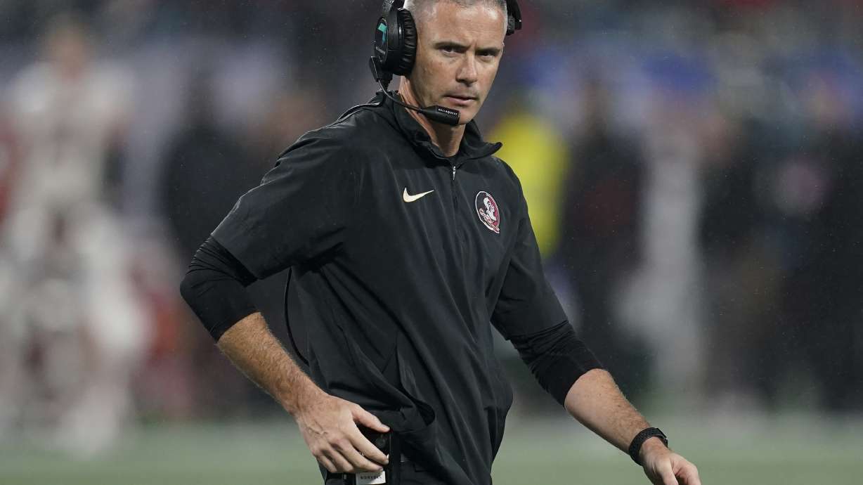 FILE - Florida State coach Mike Norvell walks on the field during a timeout in the second half of the team's Atlantic Coast Conference championship NCAA college football game against Louisville, Dec. 2, 2023, in Charlotte, N.C. Unbeaten Florida State was snubbed by the College Football Playoff last season. Norvell echoed the sentiment of other coaches, saying the ACC needs to fight its perception problem. “(We) have to continue to push the actual narrative or what needs to be the realistic narrative of how good this this league is,” he said.