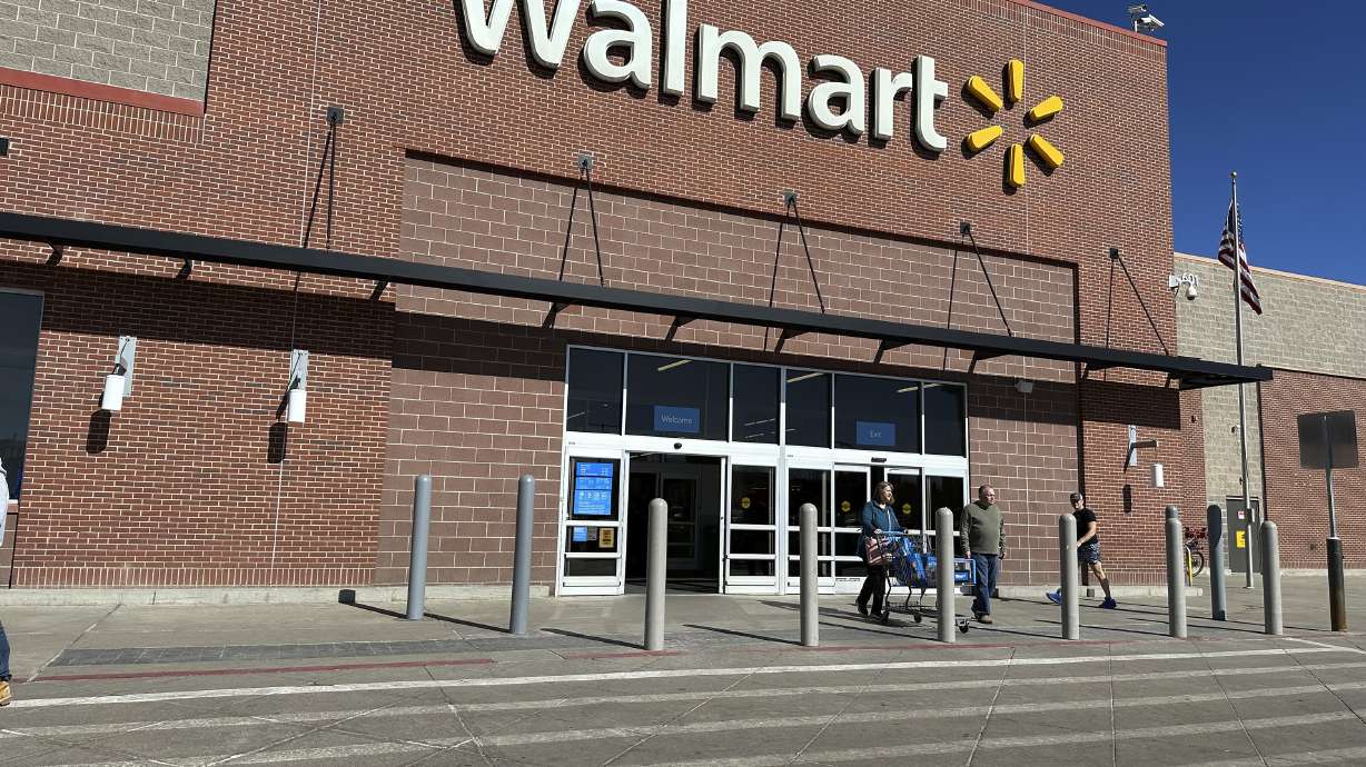Shoppers exit a Walmart store, Feb. 21, in Englewood, Colo. Walmart on Tuesday announced layoffs affecting several hundred jobs at the retail giant’s campus offices.