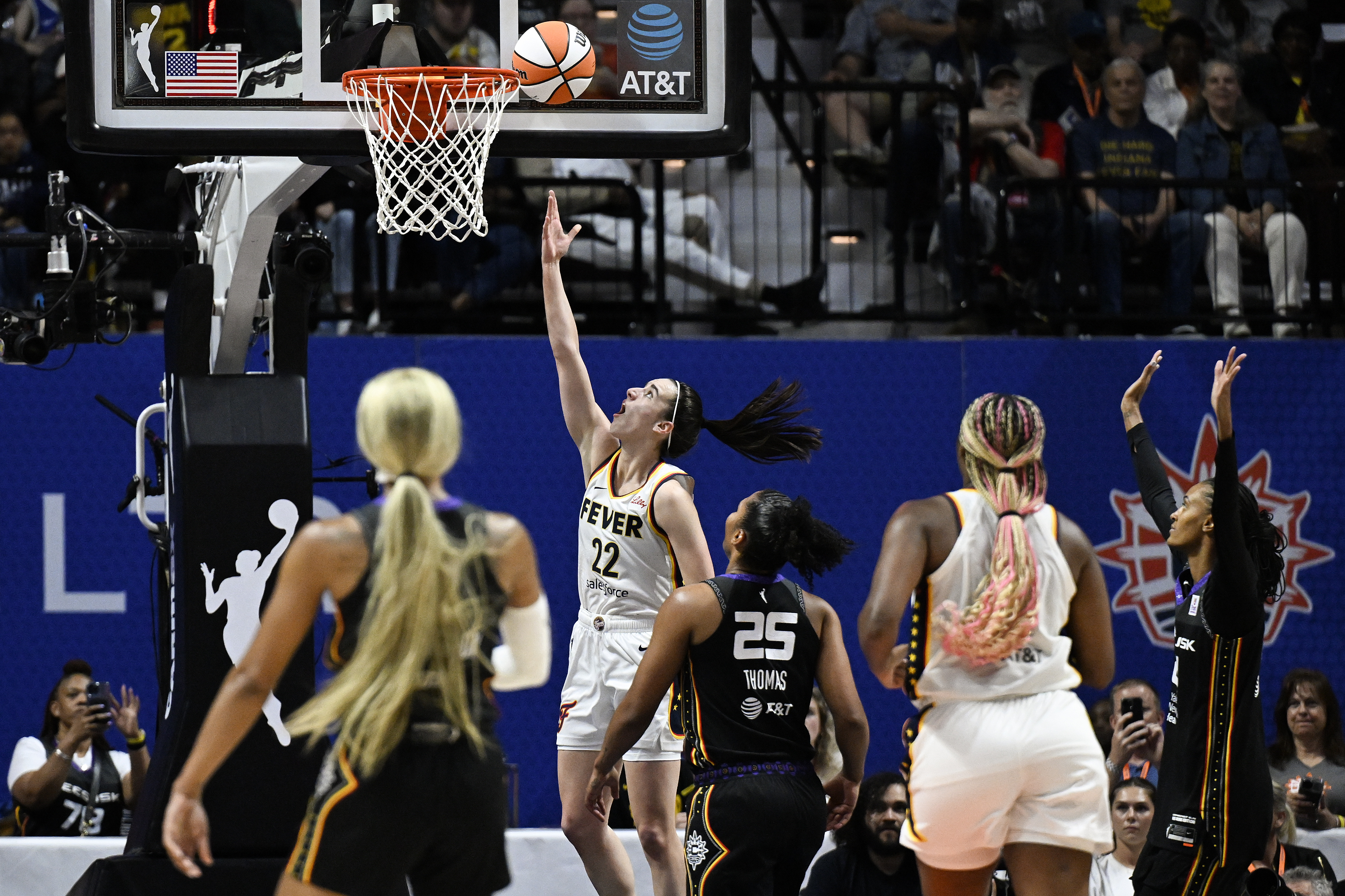 Indiana Fever guard Caitlin Clark (22) scores her first basket against the Connecticut Sun during the second quarter of a WNBA basketball game, Tuesday, May 14, 2024, in Uncasville, Conn. 