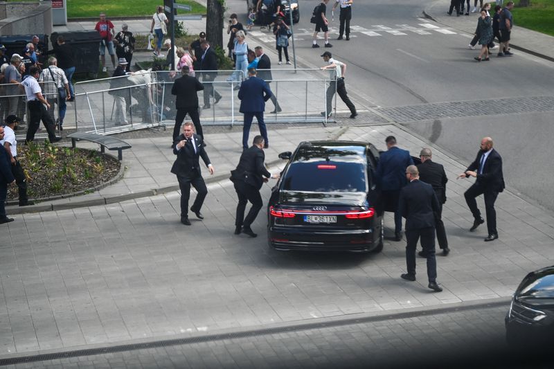 Security officers move Slovak Prime Minister Robert Fico in a car after a shooting incident, after a Slovak government meeting in Handlova, Slovakia, Wednesday.