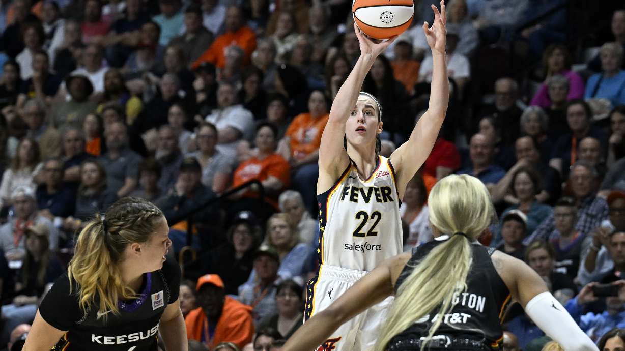 Indiana Fever guard Caitlin Clark (22) puts up a 3-point shot to score against the Connecticut Sun during the fourth quarter of a WNBA basketball game, Tuesday, May 14, 2024, in Uncasville, Conn.