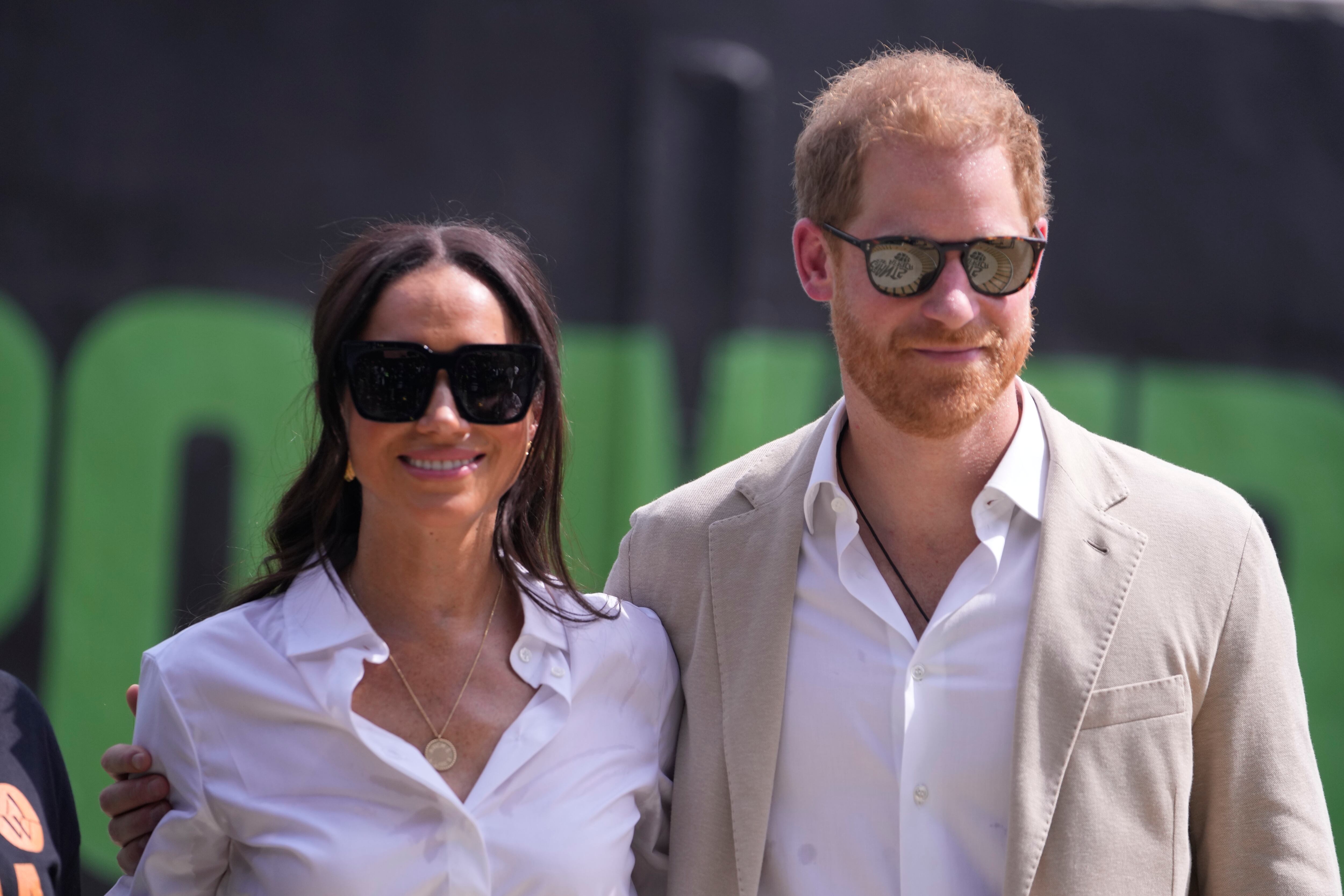 Prince Harry, right, and Meghan, left, attend the Giant of Africa Foundation at the Dream Big Basketball clinic in Lagos, Nigeria, Sunday. They are in Nigeria to champion the Invictus Games, which Prince Harry founded.