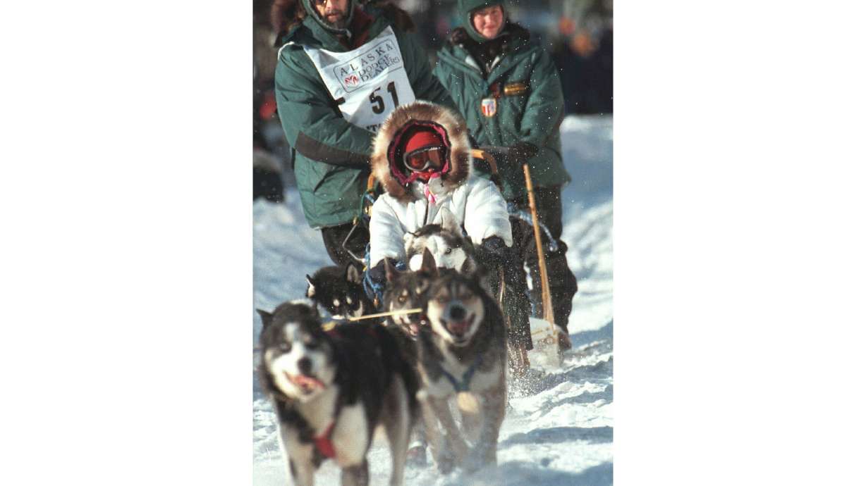 FILE - In this March 6, 1999, file photo, soap opera star Susan Lucci takes a ride in the sled of musher Rick Mackey at the start of the 27th Iditarod Trail Sled Dog Race in Anchorage, Alaska. Mackey, the winner of the 1983 Iditarod Trail Sled Dog Race, has died of lung cancer, his daughter Brenda told The Associated Press, Wednesday, May 11, 2024. Mackey, who died Monday, May 13, was 71.