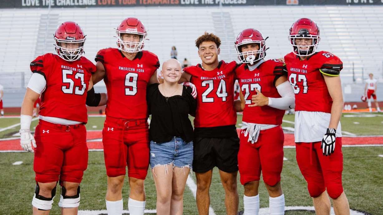 Samantha Corey with members of the American Fork High School football team. Alpine School District approved an exception to allow the Corey family to honor Samantha, who died from cancer in January, at graduation.
