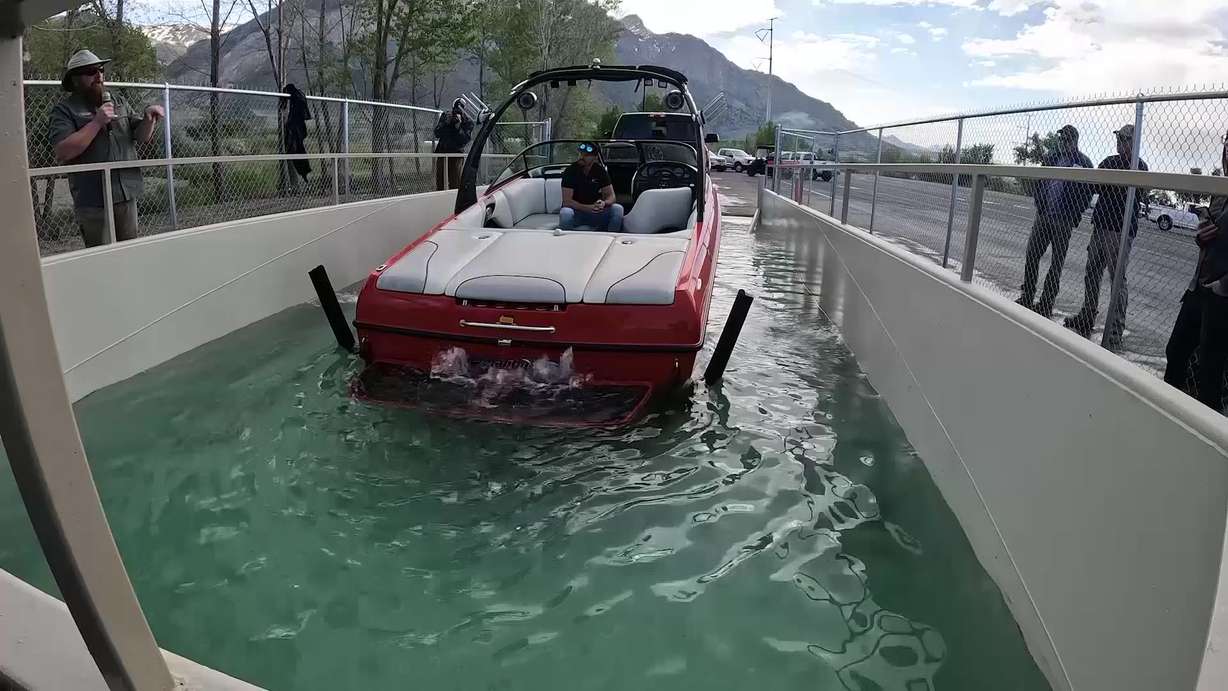 A quagga dip tank at Lake Powell as a boat enters the tank to be decontaminated from quagga mussels. After boaters at Lake Powell regularly spent hours in a decontamination line to rid their boats of quagga mussels, the Utah Divison of Wildlife Resources discovered a way to condense that line to just minutes.