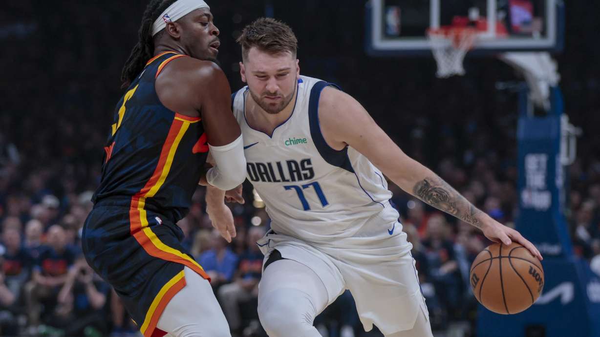 Dallas Mavericks guard Luka Doncic (77) drives against Oklahoma City Thunder guard Luguentz Dort during the first half of Game 5 of an NBA basketball second-round playoff series, Wednesday, May 15, 2024, in Oklahoma City.