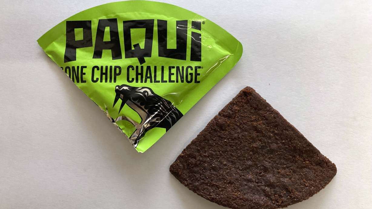 A Paqui One Chip Challenge chip displayed in Boston, Sept. 8, 2023. A medical examiner says a Massachusetts teen who died after participating in a spicy tortilla chip challenge says his death was caused by eating a large quantity of chile pepper extract. He also had a congenital heart defect.