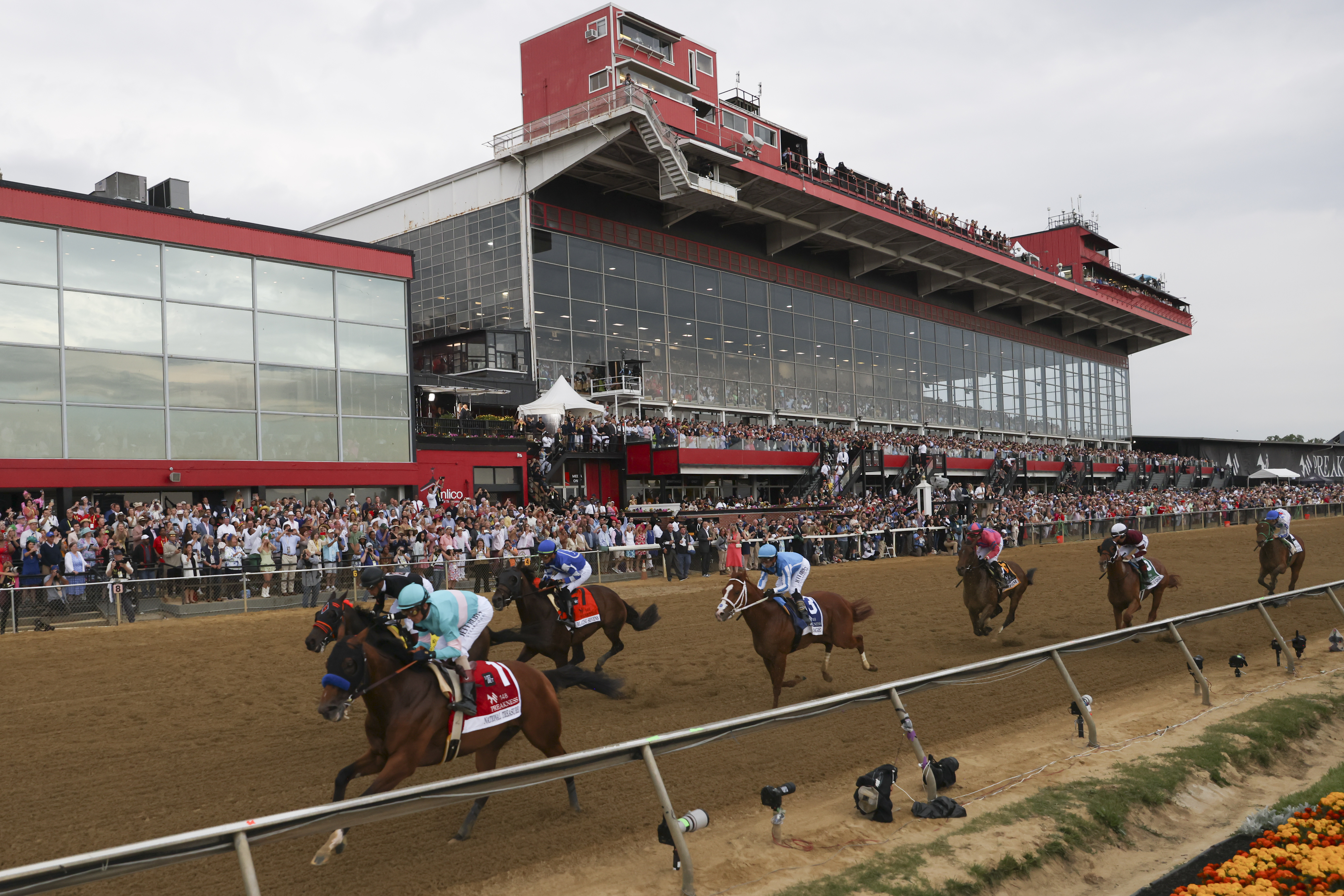 FILE - National Treasure, bottom left, with John Velazquez, leads the pack toward the first turn during the148th running of the Preakness Stakes horse race at Pimlico Race Course, May 20, 2023, in Baltimore. Maryland Gov. Wes Moore signed a measure on Thursday, May 9, 2024, to rebuild Baltimore’s historic but antiquated Pimlico Race Course and transfer the track to state control. 