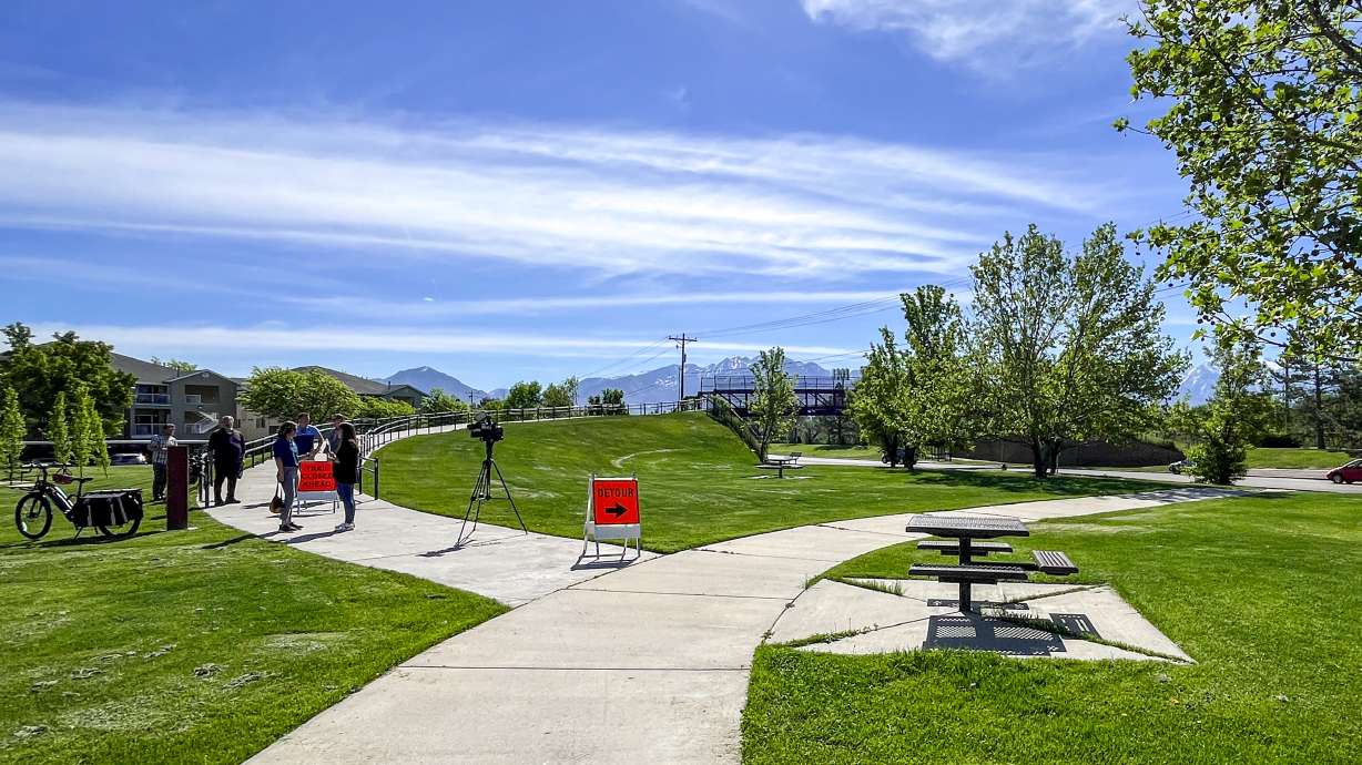 UDOT officials speak near the Jordan River Parkway Trail at General Holm Park in South Salt Lake on Thursday. Utah awarded $95 million toward trail projects this year.