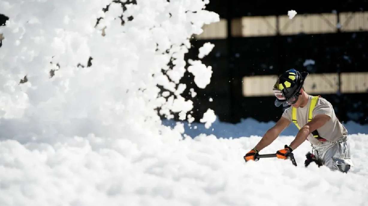 A firefighter works to clean fire-retardant foam at Travis Air Force Base in California on Sept. 24, 2013. With an Oct. 1 deadline looming, Hill Air Force Base and the Utah National Guard are working to swap out old firefighting foam with a safer product.