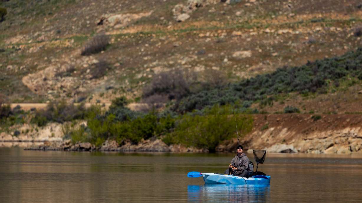 Clint Bales kayaks around Deer Creek Reservoir at Deer Creek State Park in Wallsburg on May 10. Deer Creek Reservoir is one of several Utah reservoirs near full capacity as the state's snowpack continues to melt.