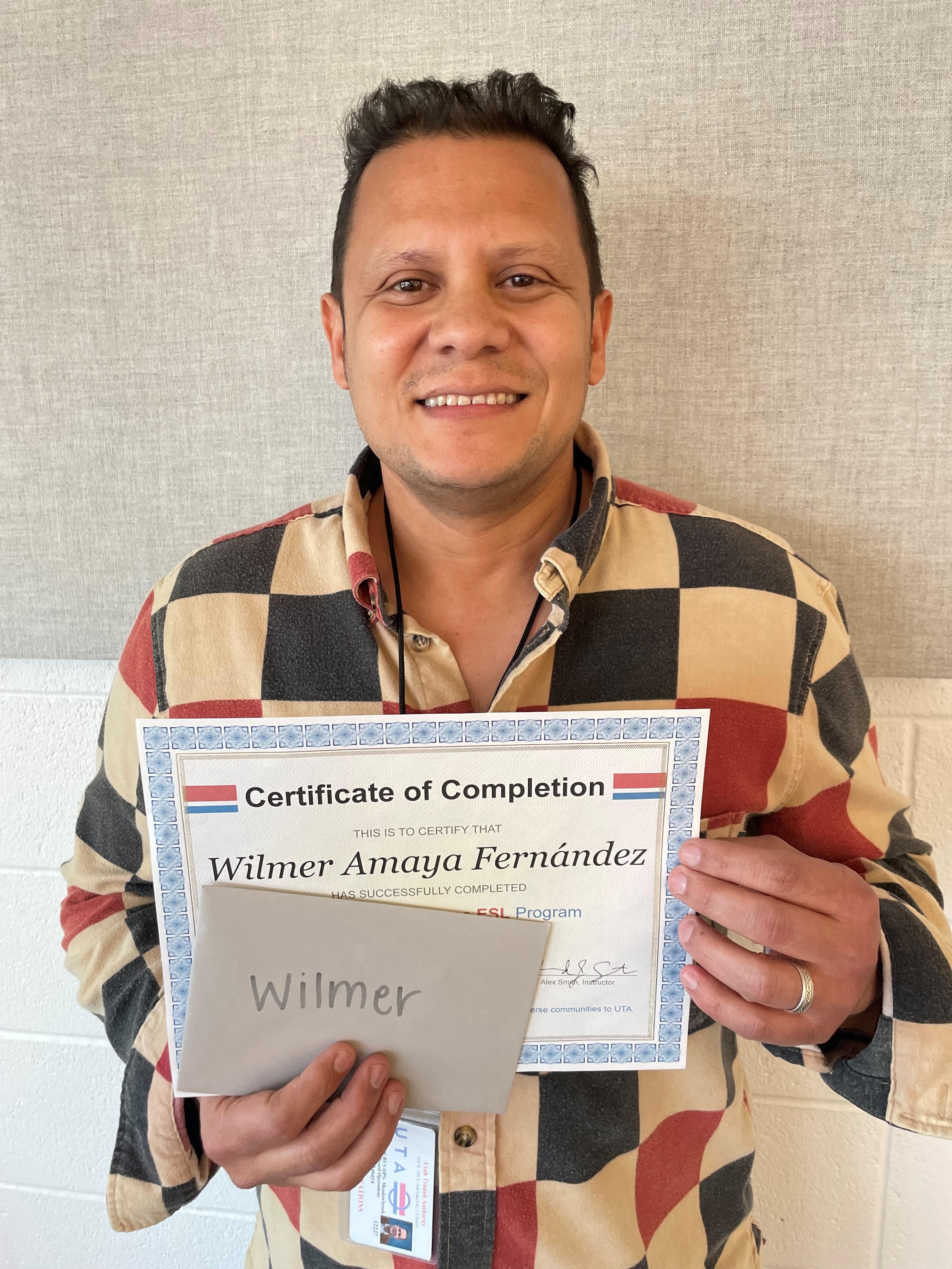 Wilmer Amaya Fernandez shows his certificate of completion from the English instruction portion of a Utah Transit Authority driver recruitment program geared to immigrants. He received the certificate at a ceremony on Wednesday.