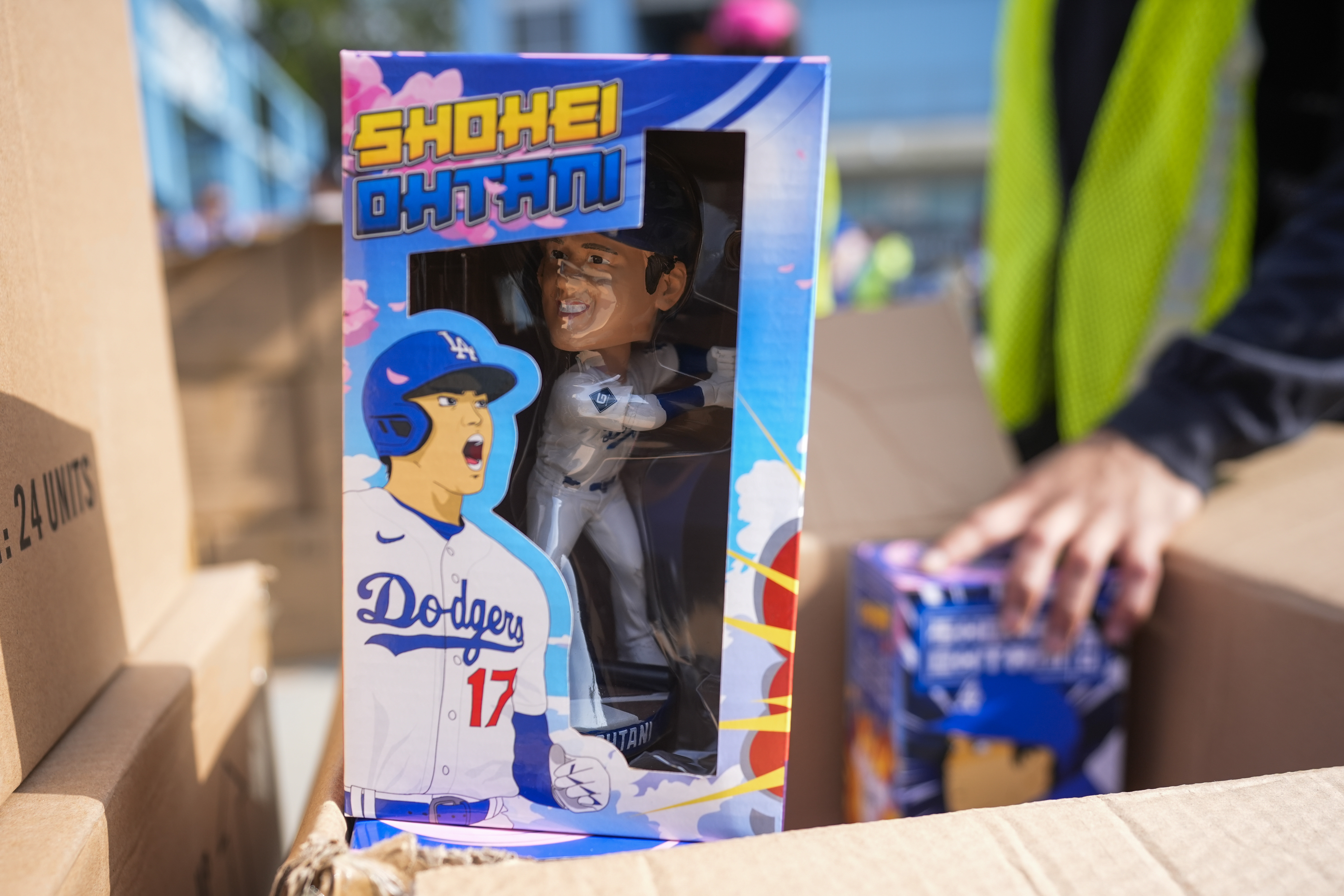 Bobbleheads of Los Angeles Dodgers designated hitter Shohei Ohtani are given to fans before a baseball game against the Cincinnati Reds in Los Angeles, Thursday, May 16, 2024.