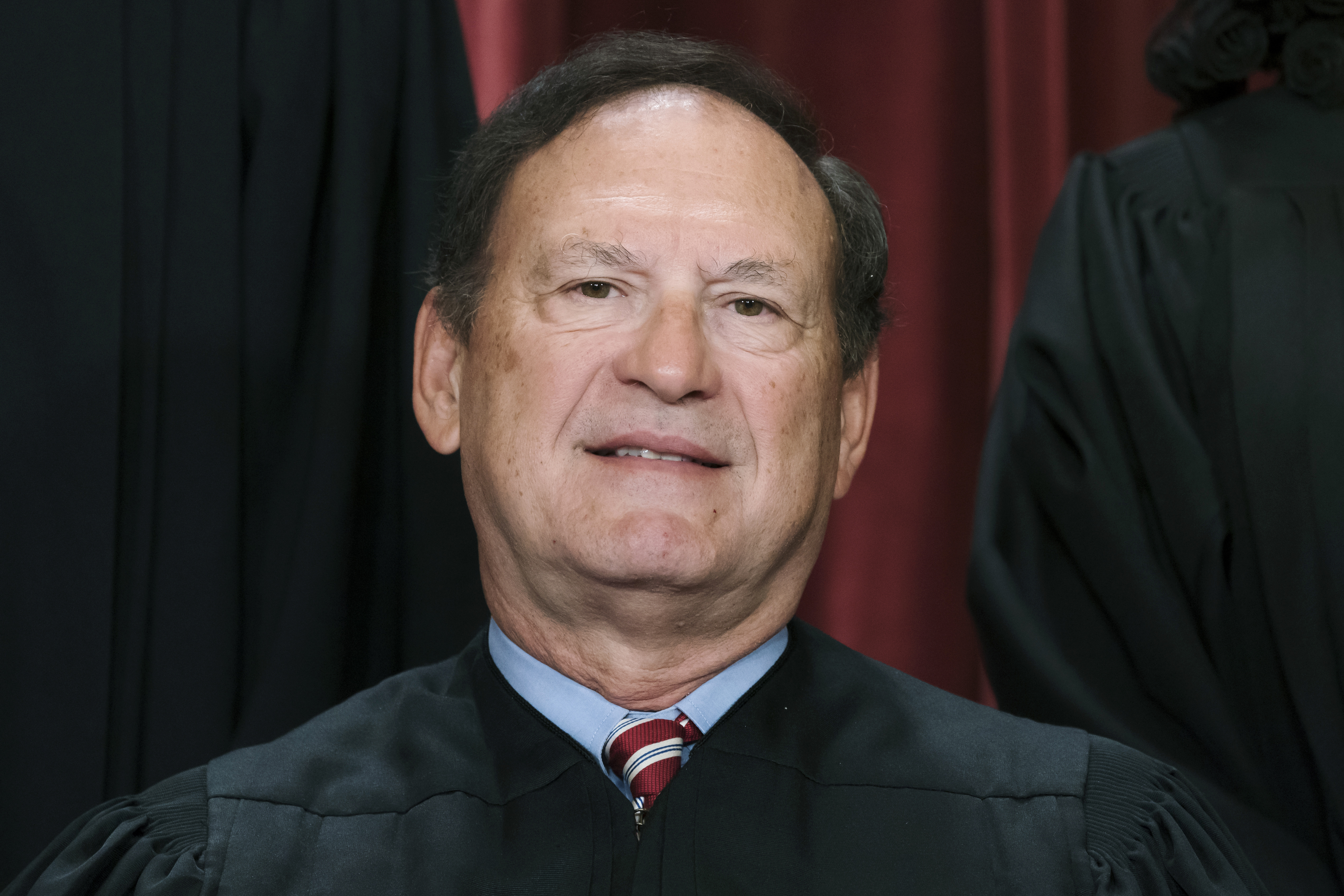Associate Justice Samuel Alito and other members of the Supreme Court pose for a new group portrait, Oct. 7, 2022. An upside-down American flag, a symbol associated with former President Donald Trump's false claims of election fraud, was displayed outside the home of Alito in January 2021, The New York Times reported Thursday.