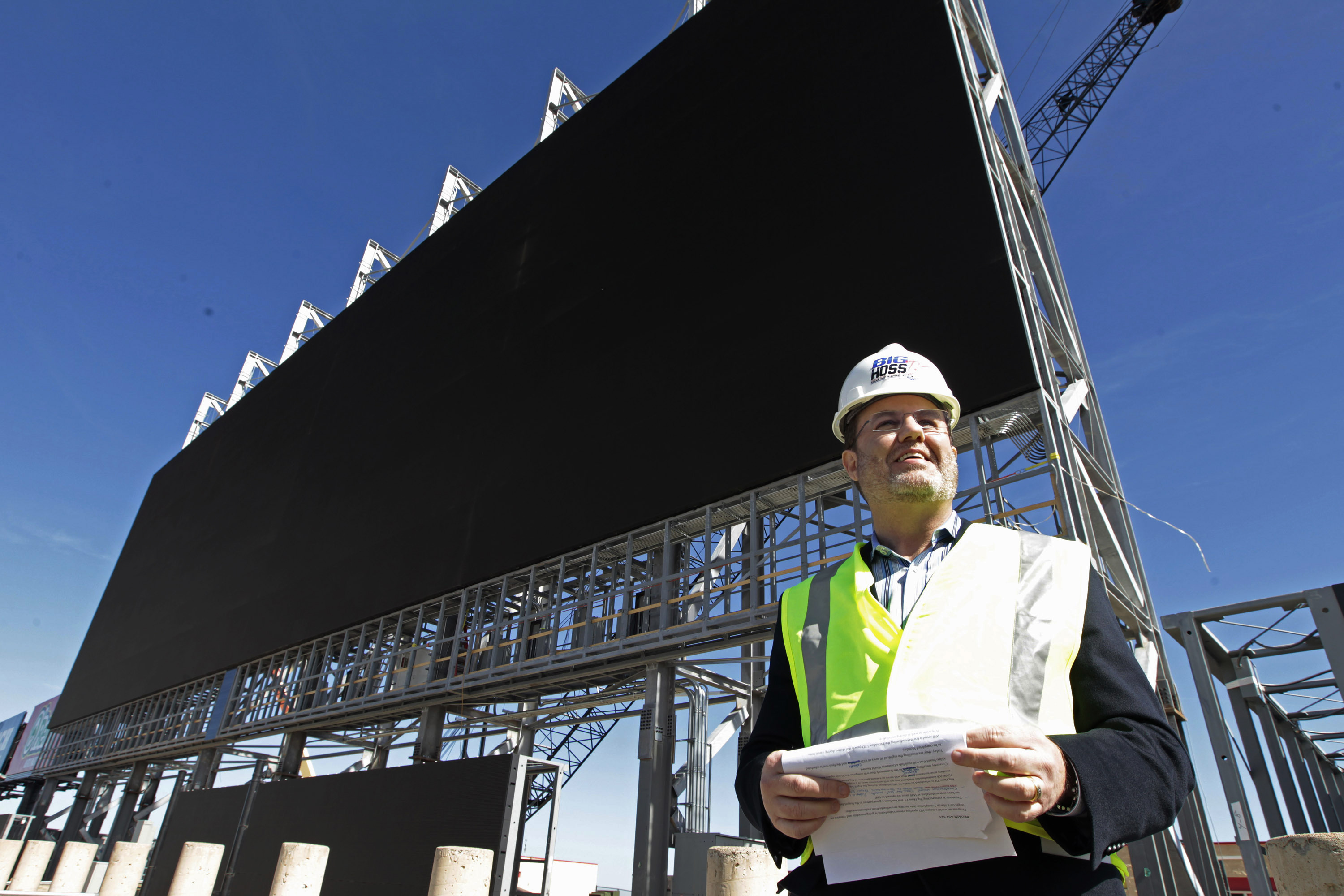 FILE - Texas Motor Speedway President Eddie Gossage gives a tour of the large television screen being constructed at the track, Feb. 14, 2014, in Fort Worth, Texas. Gossage, an old-school promoter mentored by stock car racing pioneers, has died at the age of 65, Speedway Motorsports announced Thursday night, May 16, 2024. 