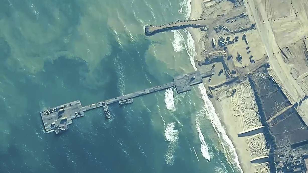 The image provided by U.S. Central Command, shows U.S. Army soldiers assigned to the 7th Transportation Brigade (Expeditionary), U.S. Navy sailors assigned to Amphibious Construction Battalion 1, and Israel Defense Forces placing the Trident Pier on the coast of Gaza Strip on Thursday.