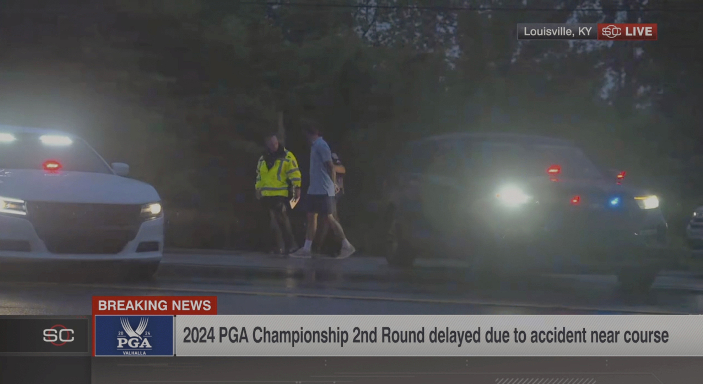 In this still image made from video provided by ESPN, Masters champions Scottie Scheffler is escorted by police after being handcuffed near Valhalla Golf Club, site of the PGA Championship golf tournament, early Friday.