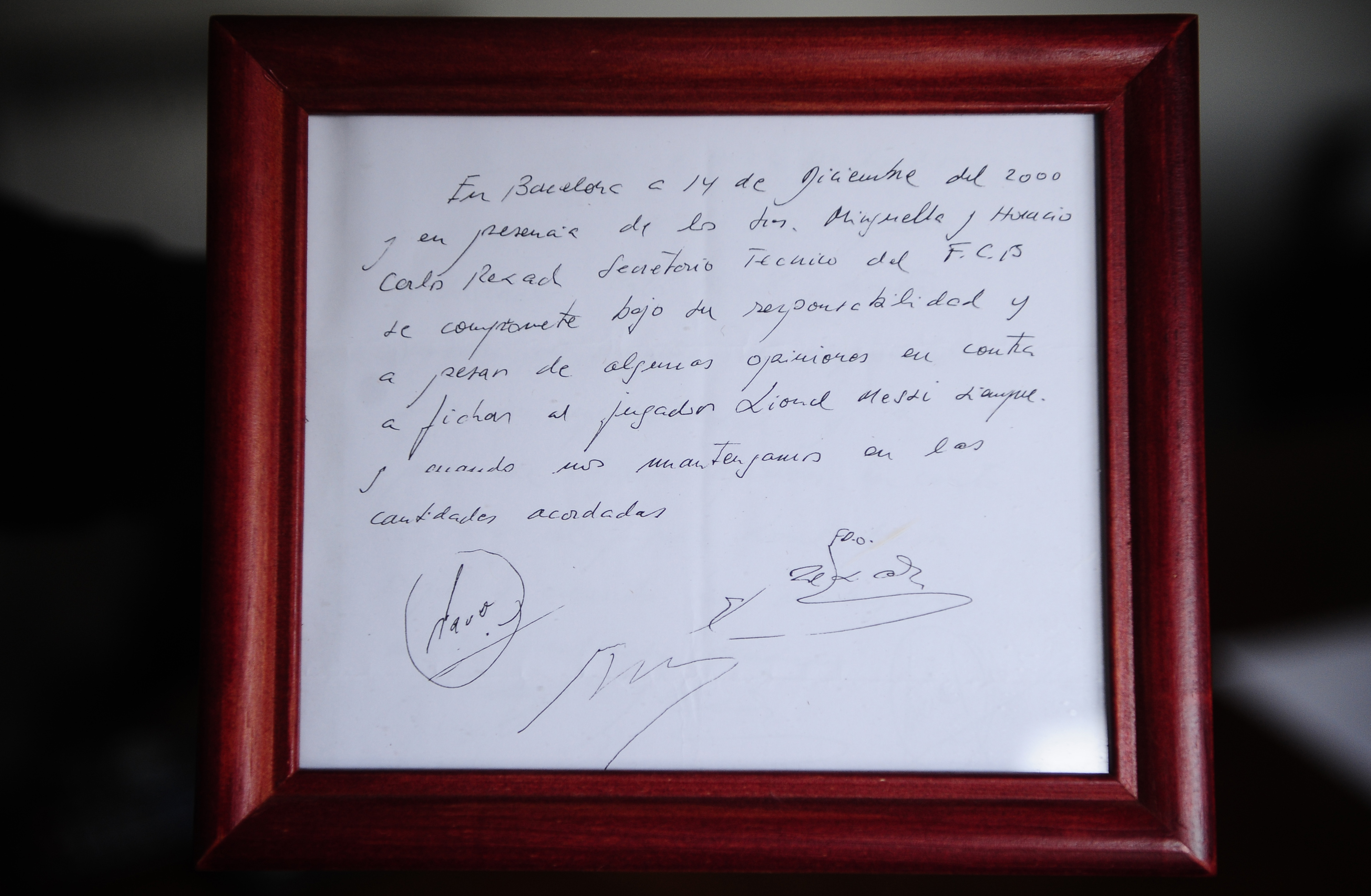 FILE - A framed copy of the napkin linking the 13-year-old Lionel Messi to FC Barcelona is seen in Barcelona, Spain on Jan. 5, 2012. British auction house Bonhams says the famous napkin that linked a young Lionel Messi to Barcelona has sold for $965,000. An agreement in principle to sign then 13-year-old Messi was written on the napkin almost 25 years ago at a Barcelona tennis club. 