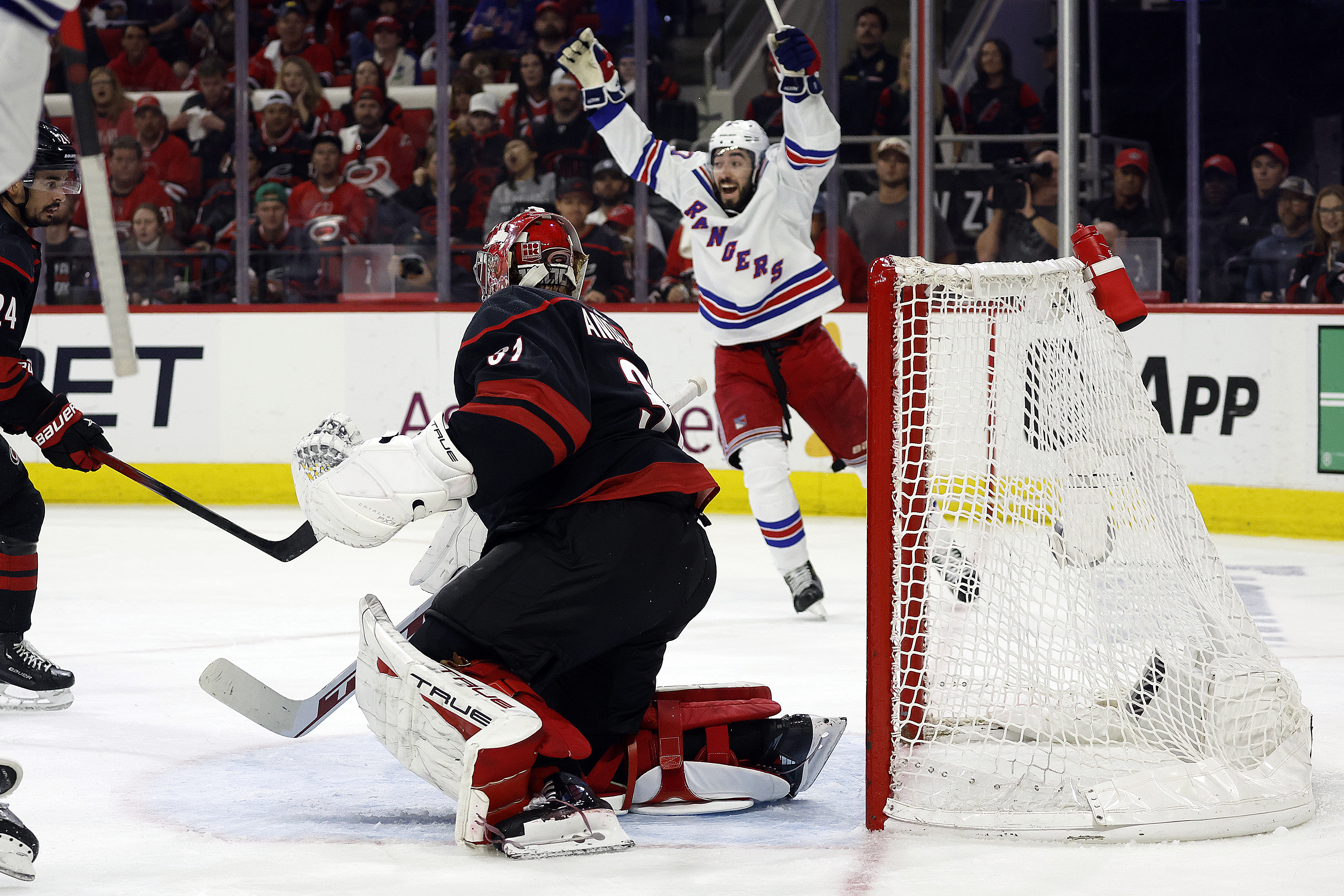 New York Rangers' Mika Zibanejad (93) celebrates a goal by Chris Kreider against Carolina Hurricanes goaltender Frederik Andersen during the third period in Game 6 of an NHL hockey Stanley Cup second-round playoff series in Raleigh, N.C., Thursday, May 16, 2024. 