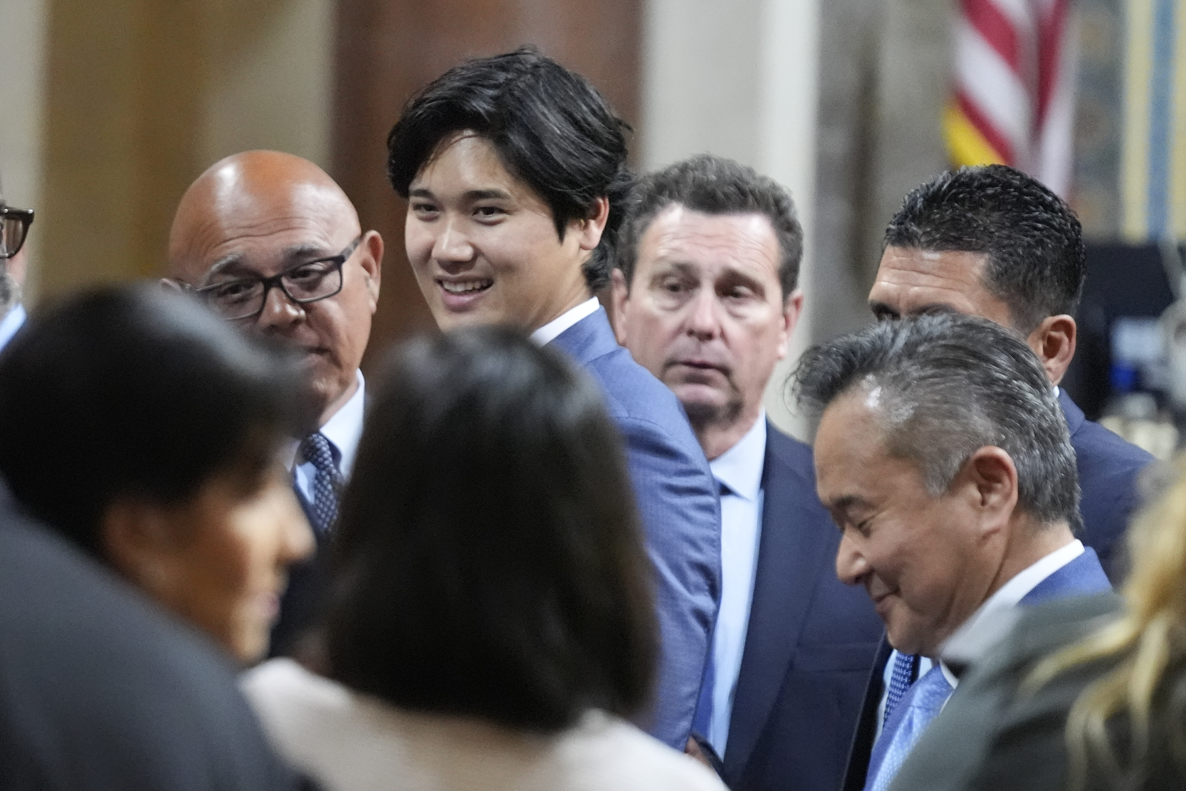 Los Angeles Dodgers baseball star Shohei Ohtani interacts with officials after being honored, Friday, May 17, 2024, during a council meeting in Los Angeles. 