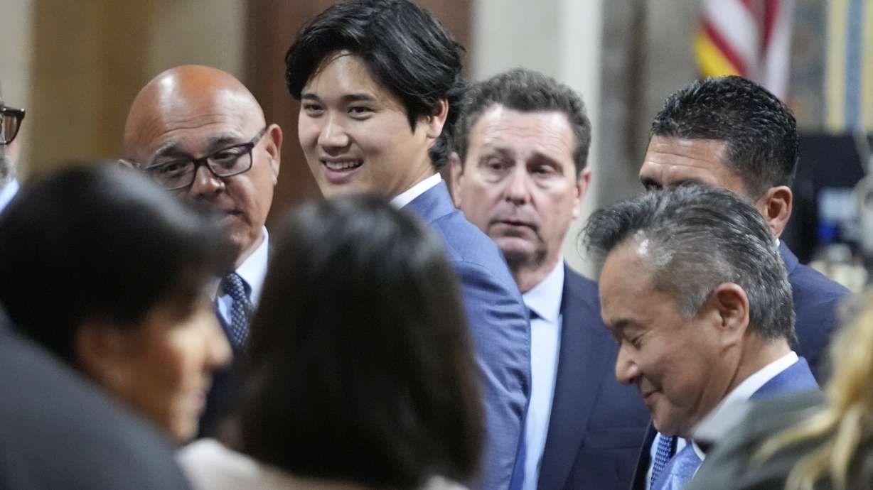 Los Angeles Dodgers baseball star Shohei Ohtani interacts with officials after being honored, Friday, May 17, 2024, during a council meeting in Los Angeles.