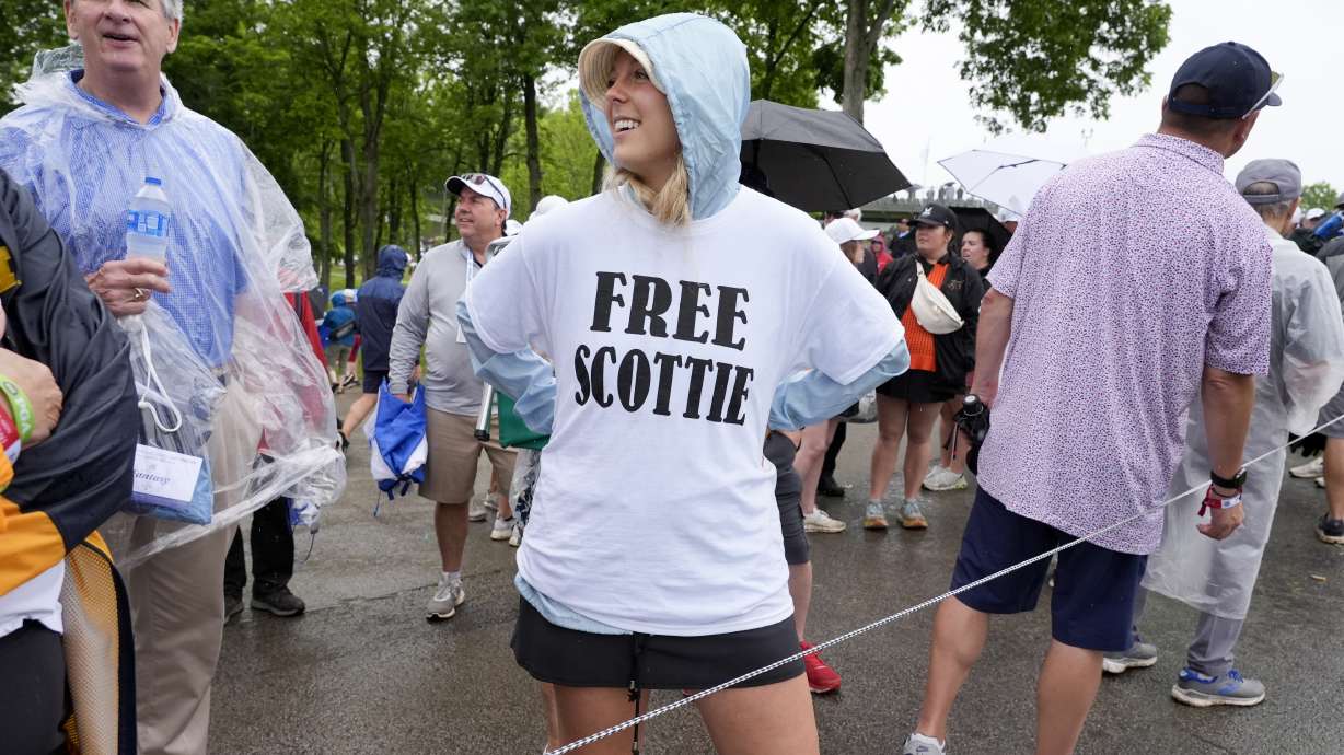 Emily Ferrando wears a T-shirt she bought in the parking lot in support of Scottie Scheffler during the second round of the PGA Championship golf tournament at the Valhalla Golf Club, Friday, May 17, 2024, in Louisville, Ky.