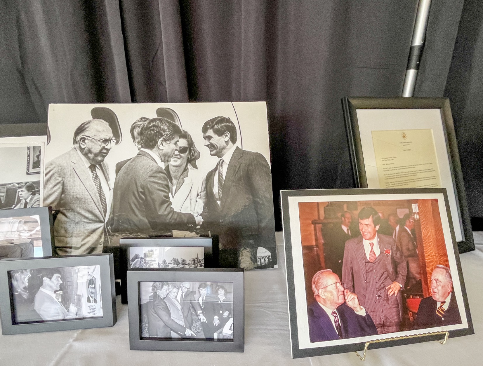 Photos of Ted Wilson from his career are displayed at a memorial service for the former Salt Lake City mayor on Friday.