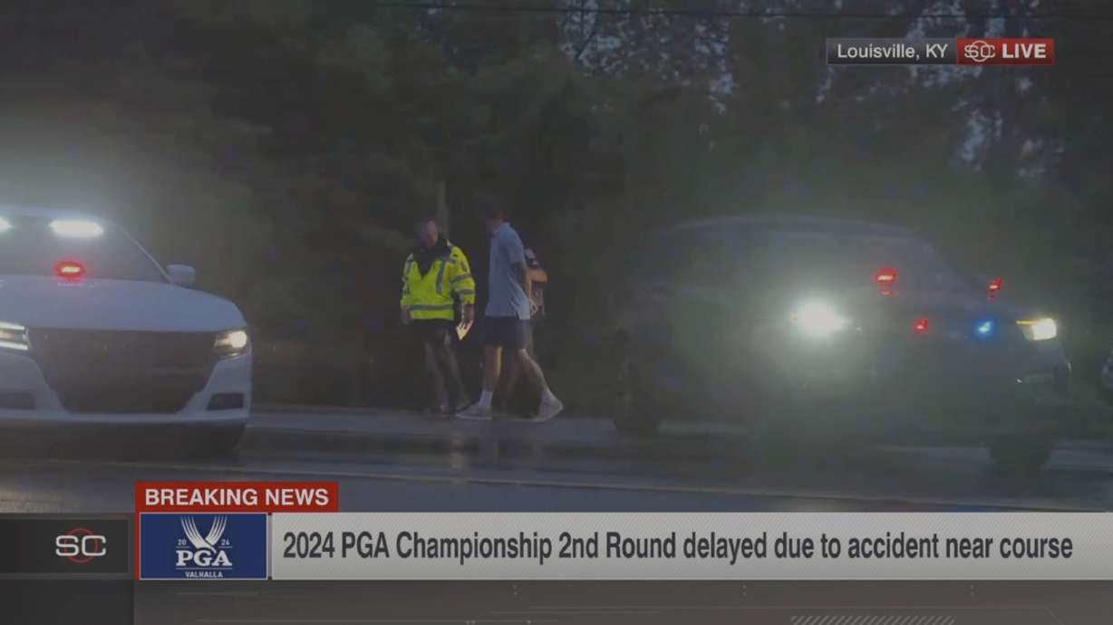 In this still image made from video provided by ESPN, Masters champion Scottie Scheffler is escorted by police after being handcuffed near Valhalla Golf Club, site of the PGA Championship golf tournament, early Friday, May 17, 2024.