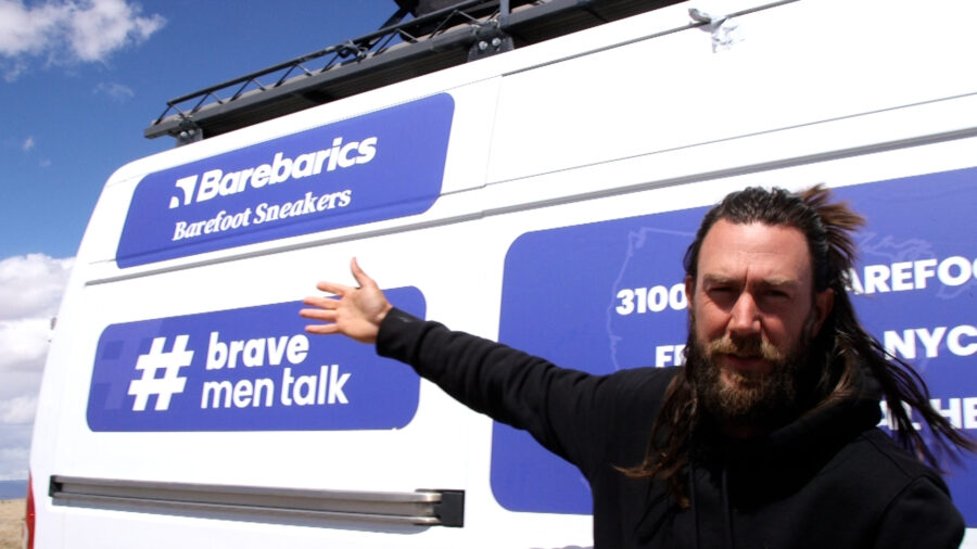 Anton Nootenboom shows off his van which features his hashtag honoring men's mental health awareness.