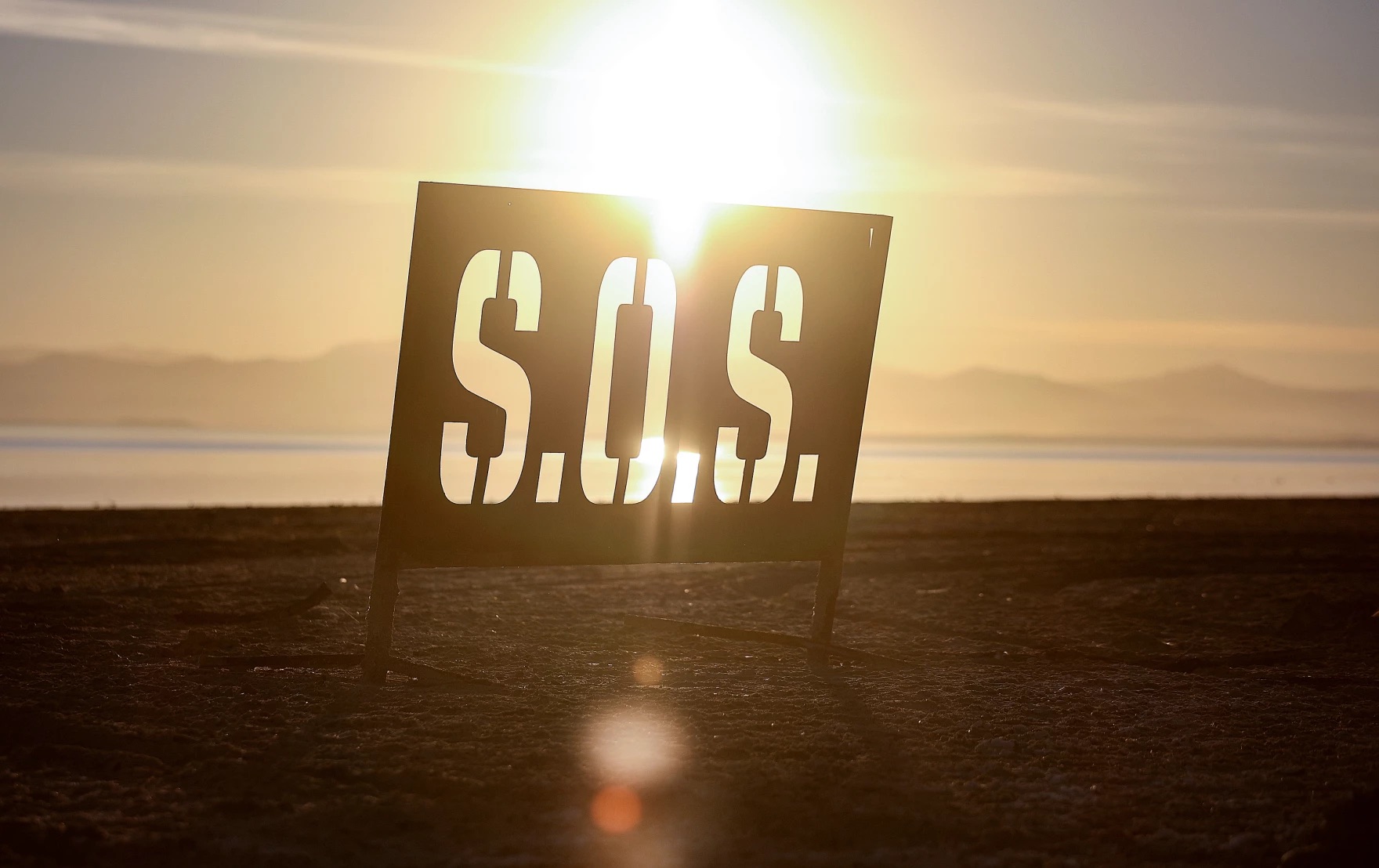 A metal S.O.S. sign is pictured on the receding shoreline of the Salton Sea in Bombay Beach, Calif., on Dec. 15, 2023.