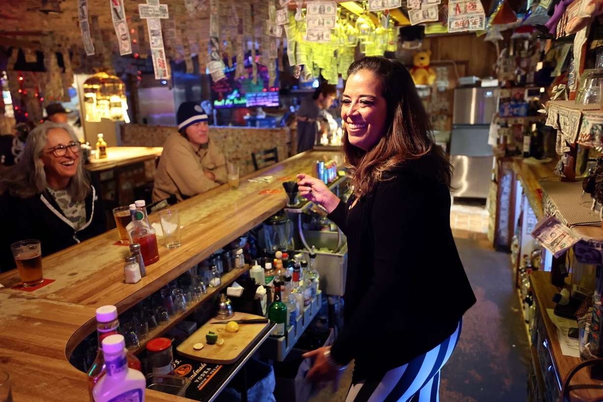 Tala Satele tends bar at the Ski Inn in Bombay Beach, Calif., on Dec. 15, 2023.