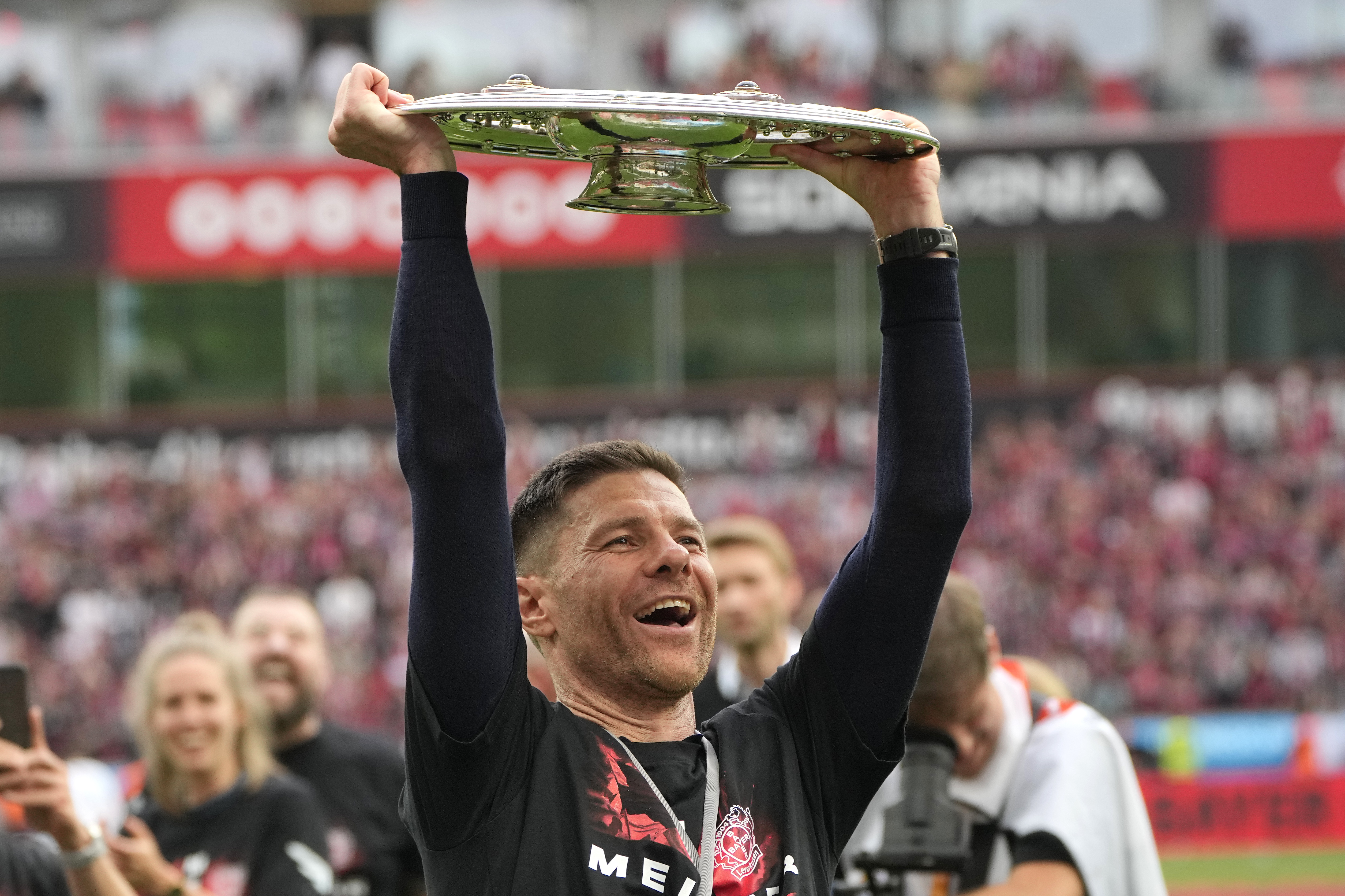 Leverkusen's head coach Xabi Alonso celebrates with the trophy as his team won the German Bundesliga, after the German Bundesliga soccer match between Bayer Leverkusen and FC Augsburg at the BayArena in Leverkusen, Germany, Saturday, May 18, 2024. Bayer Leverkusen have won the Bundesliga title for the first time. It is the first team in Bundesliga history, that won the championship unbeaten for the whole season. 