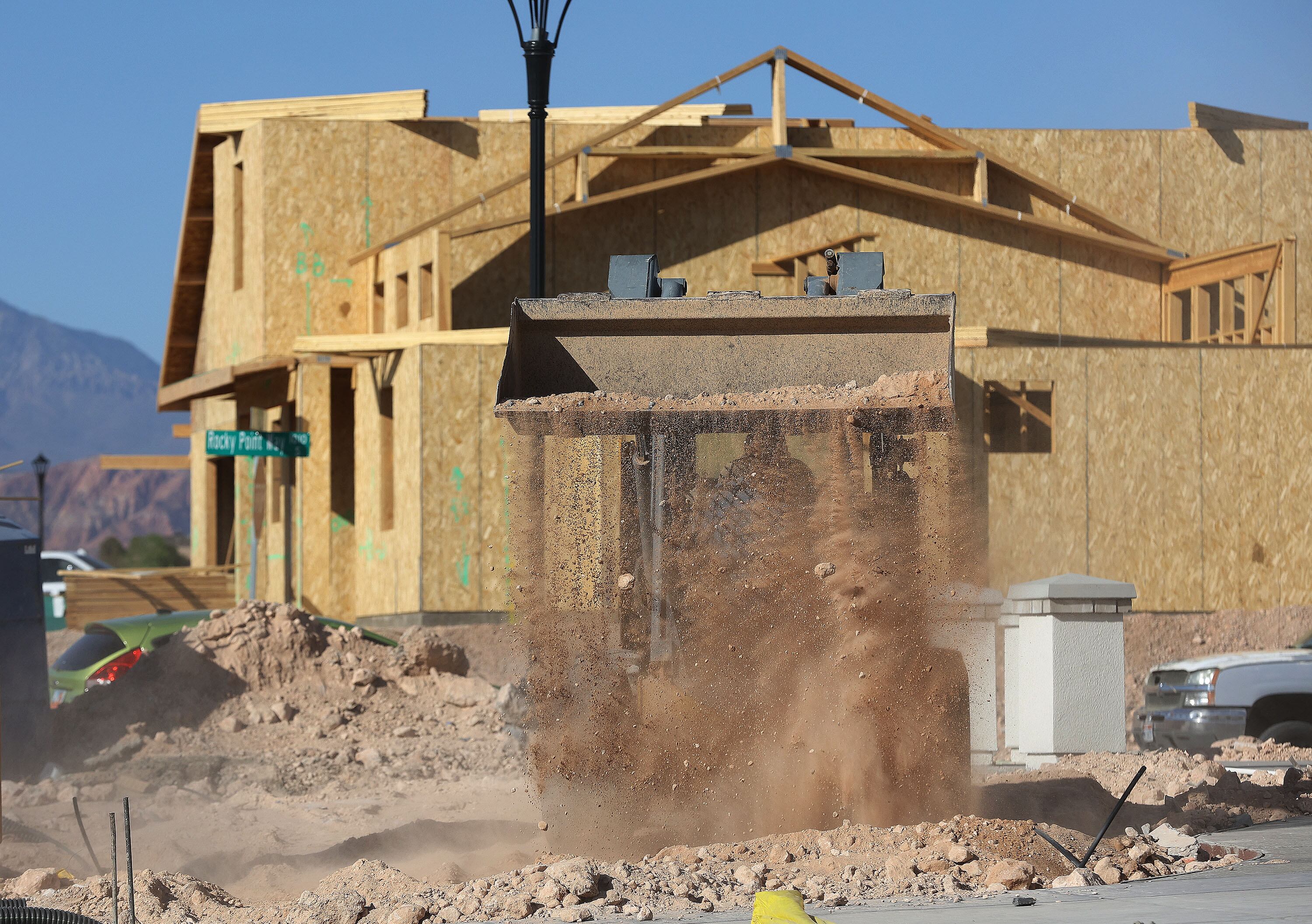 A worker moves dirt at a home that is under construction in St. George on April 8, 2021. New construction is key to saving water, including the Colorado River.