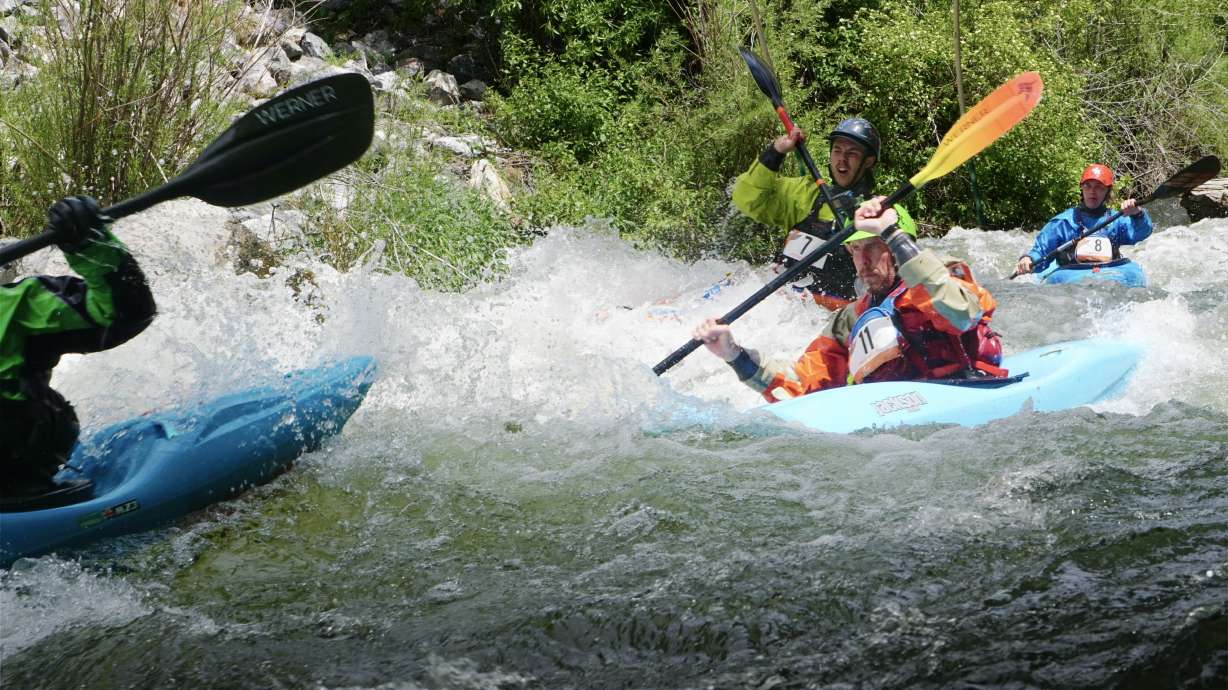 Whitewater kayakers navigate rapids through the Provo River Race Saturday.