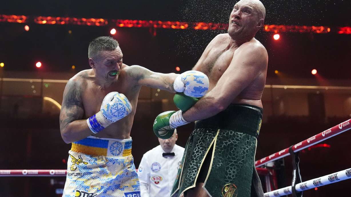 Britain’s Tyson Fury, right, takes a blow from Ukraine’s Oleksandr Usyk during their undisputed heavyweight world championship boxing fight at the Kingdom Arena in Riyadh, Saudi Arabia, Sunday, May 19, 2024.