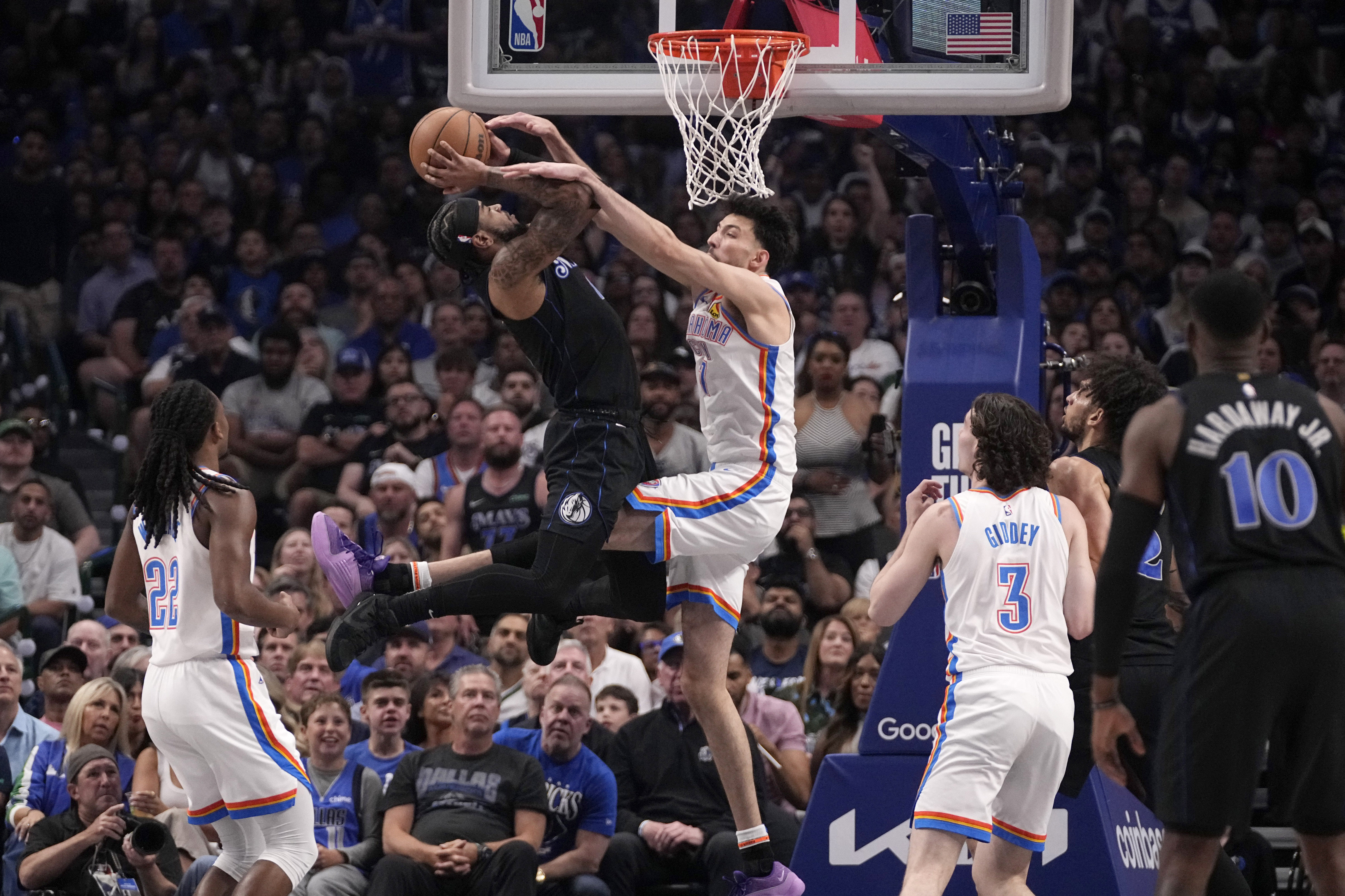 Dallas Mavericks' Jaden Hardy is fouled shooting by Oklahoma City Thunder's Chet Holmgren, center right, in the first half of Game 6 of an NBA basketball second-round playoff series Saturday, May 18, 2024, in Dallas. 