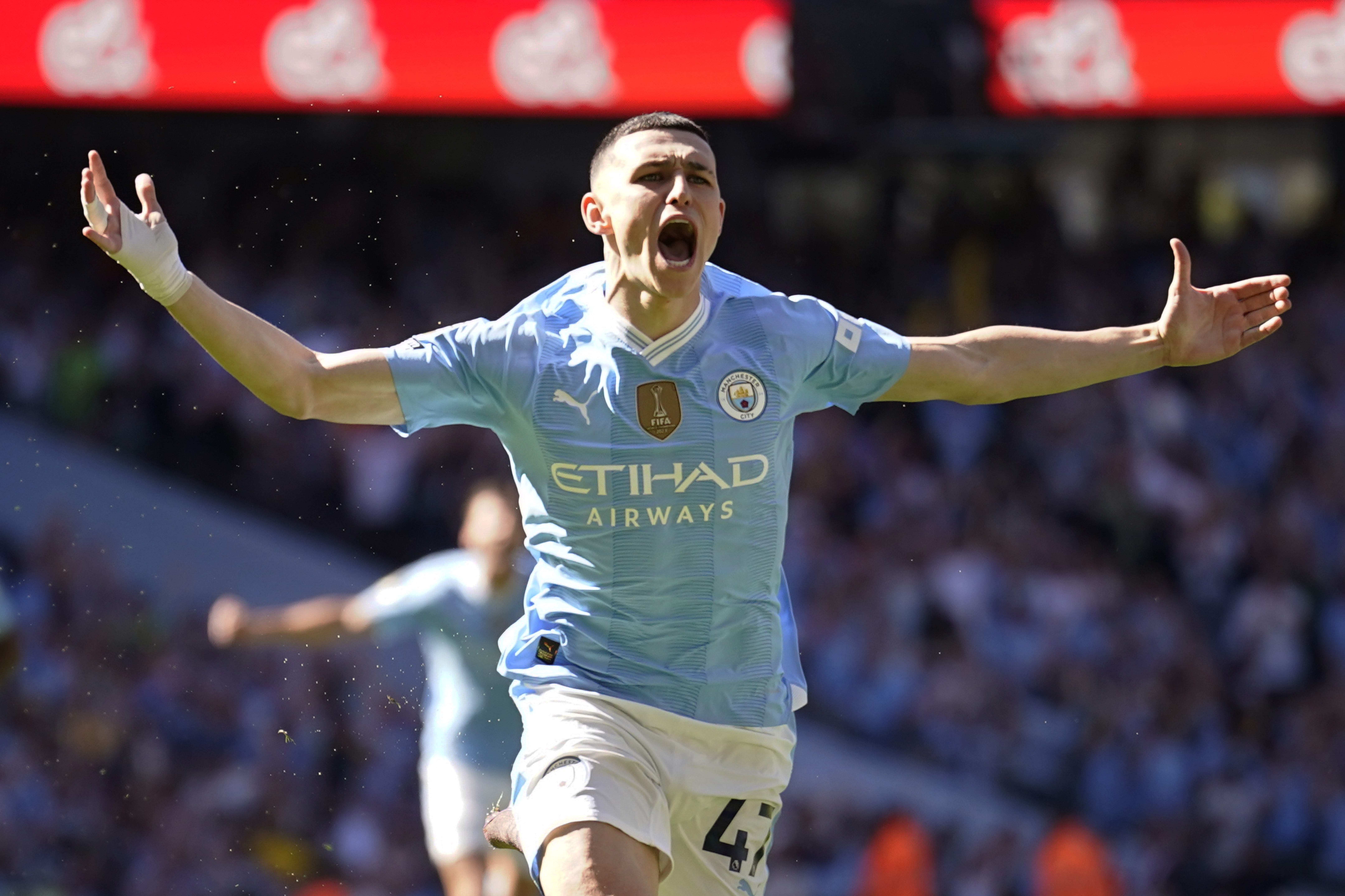 Manchester City's Phil Foden celebrates after scoring his side's opening goal during the English Premier League soccer match between Manchester City and West Ham United at the Etihad Stadium in Manchester, England, Sunday, May 19, 2024. 