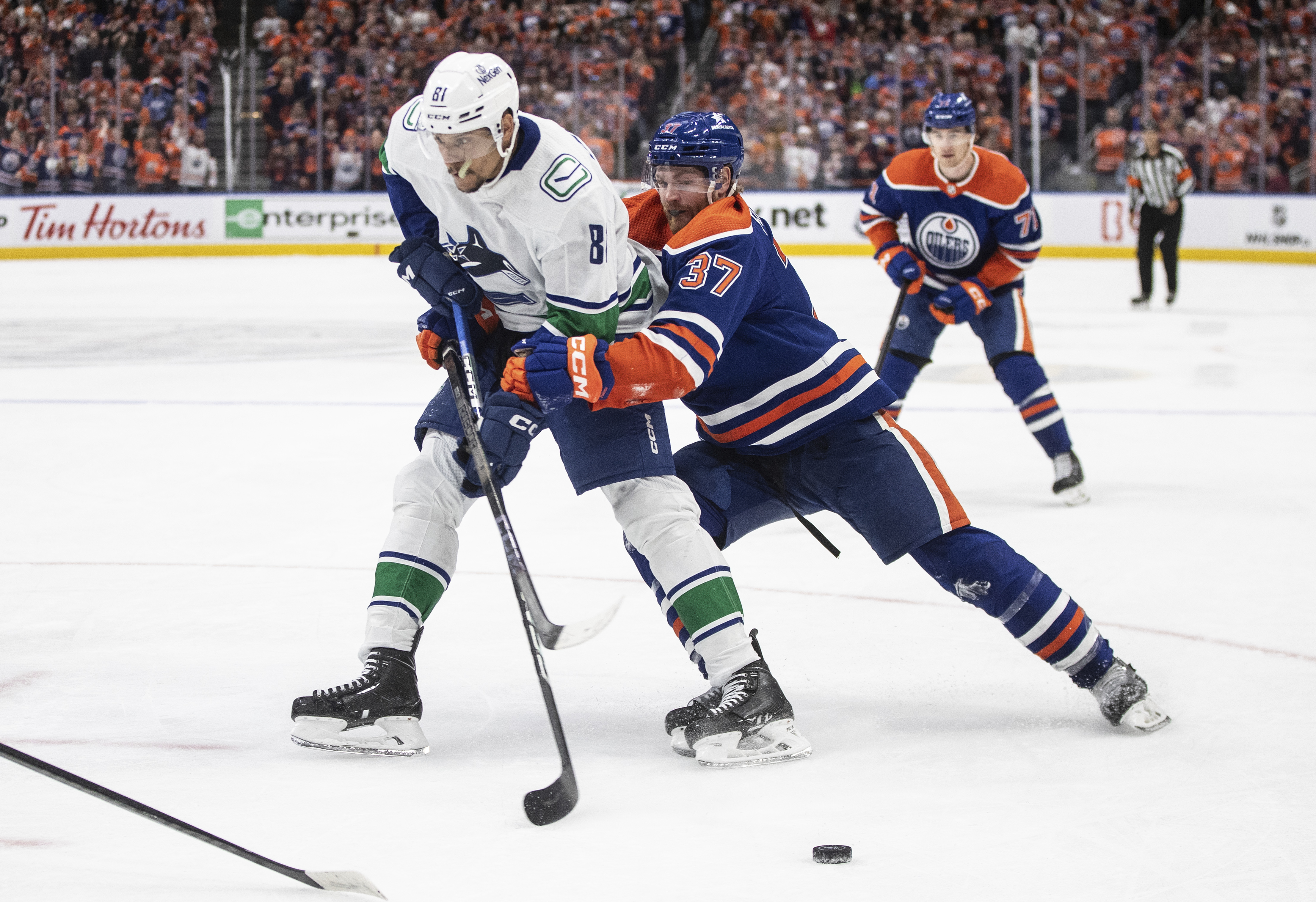 Vancouver Canucks' Dakota Joshua (81) is defended by Edmonton Oilers' Warren Foegele (37) during the third period of Game 6 of an NHL hockey Stanley Cup second-round playoff series, Saturday, May 18, 2024, in Edmonton, Alberta. 