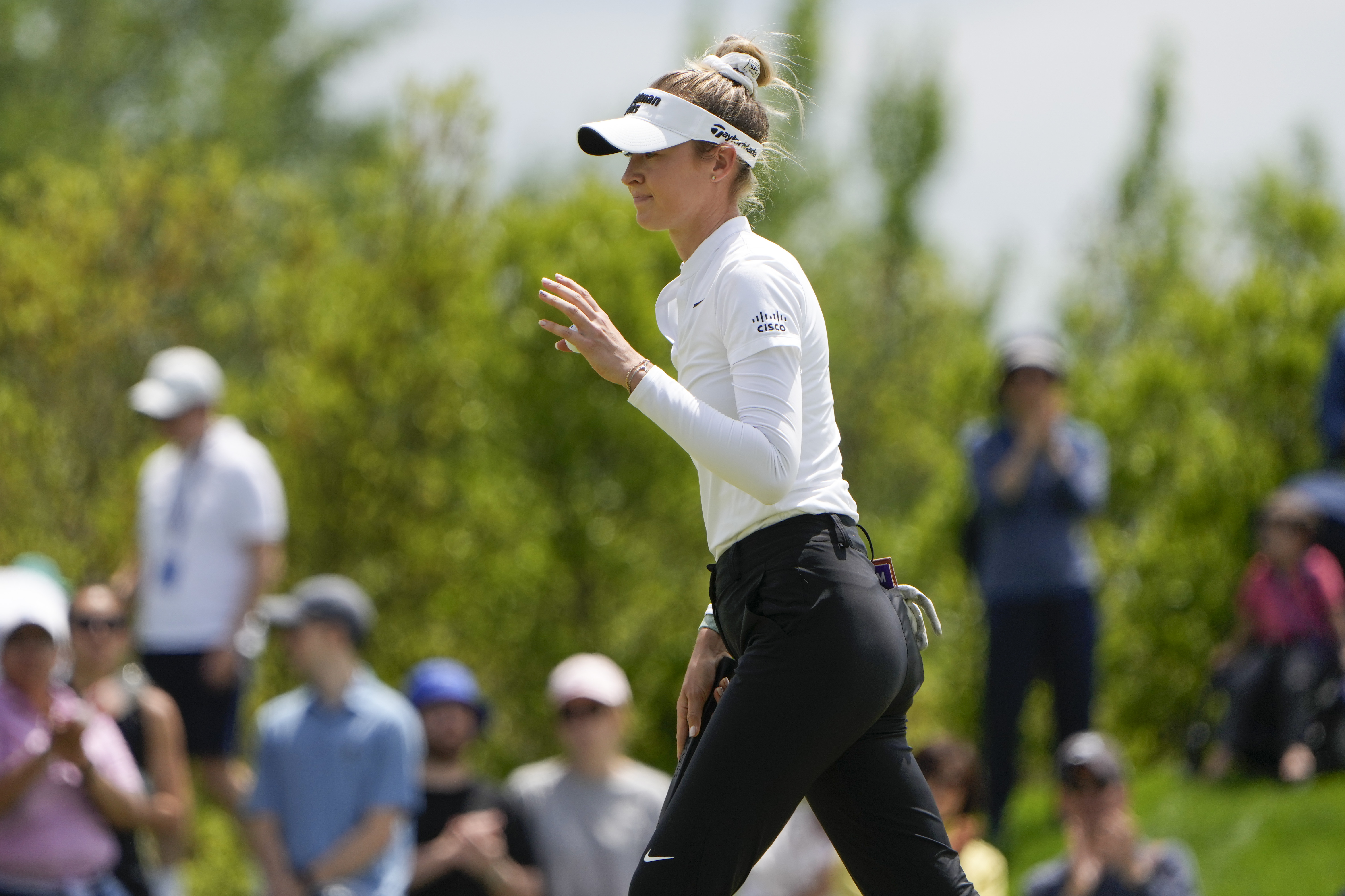 Nelly Korda holds up her ball after sinking her putt on the fourth hole during the final round of the Mizuho Americas Open golf tournament, Sunday, May 19, 2024, in Jersey City, N.J.