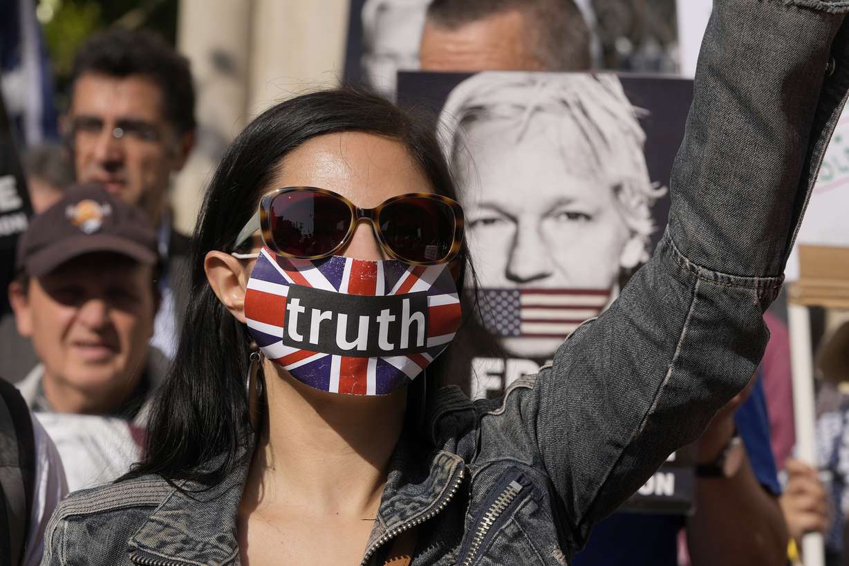 A protester stands outside the High Court in London, Monday. A British court has ruled Monday that Assange can appeal against an order that he be extradited to the U.S. on espionage charges.