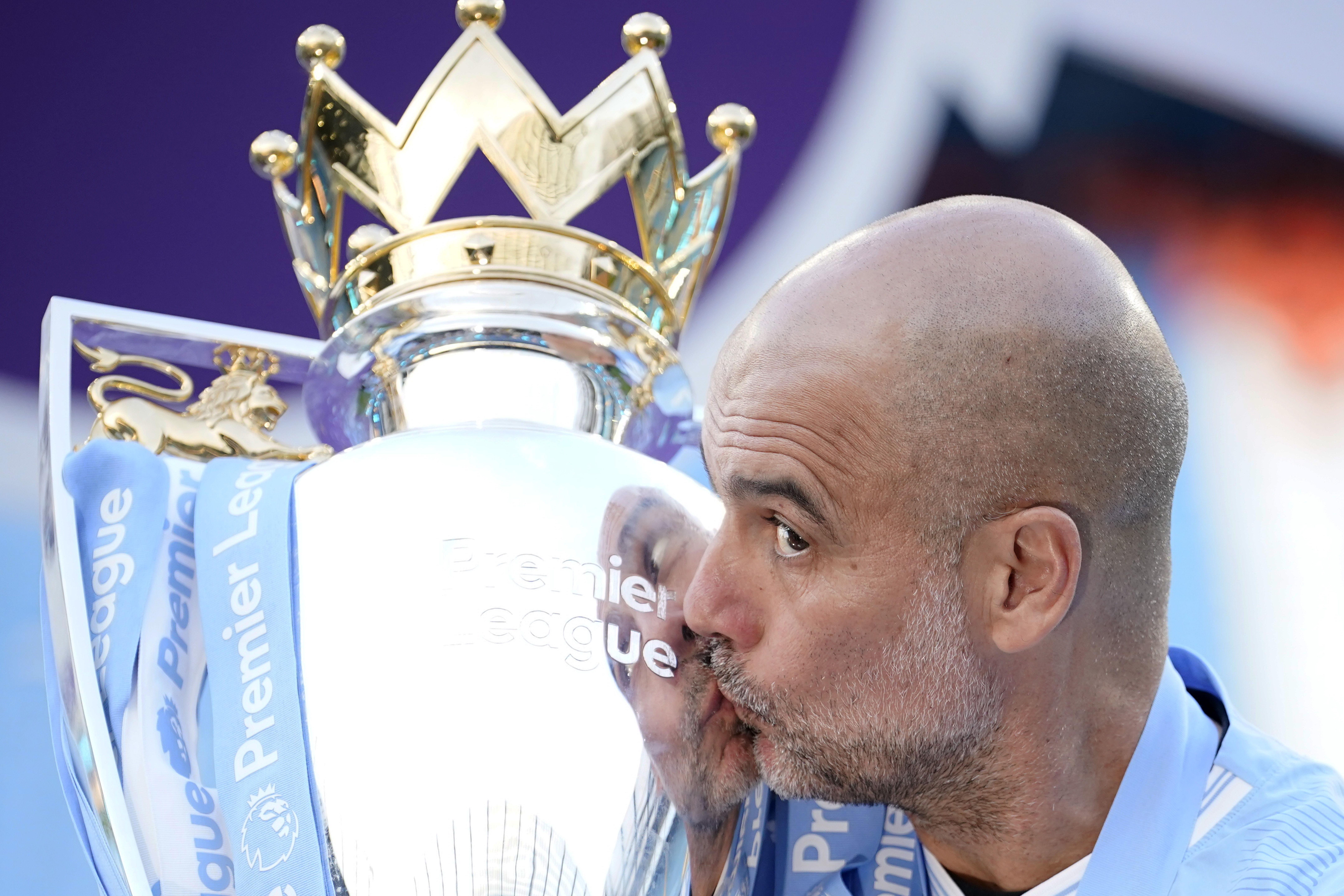 FILE - Manchester City's head coach Pep Guardiola celebrates with the Premier League trophy after the English Premier League soccer match between Manchester City and West Ham United at the Etihad Stadium in Manchester, England, Sunday, May 19, 2024. Manchester City clinched the English Premier League on Sunday after beating West Ham in their last match of the season. 