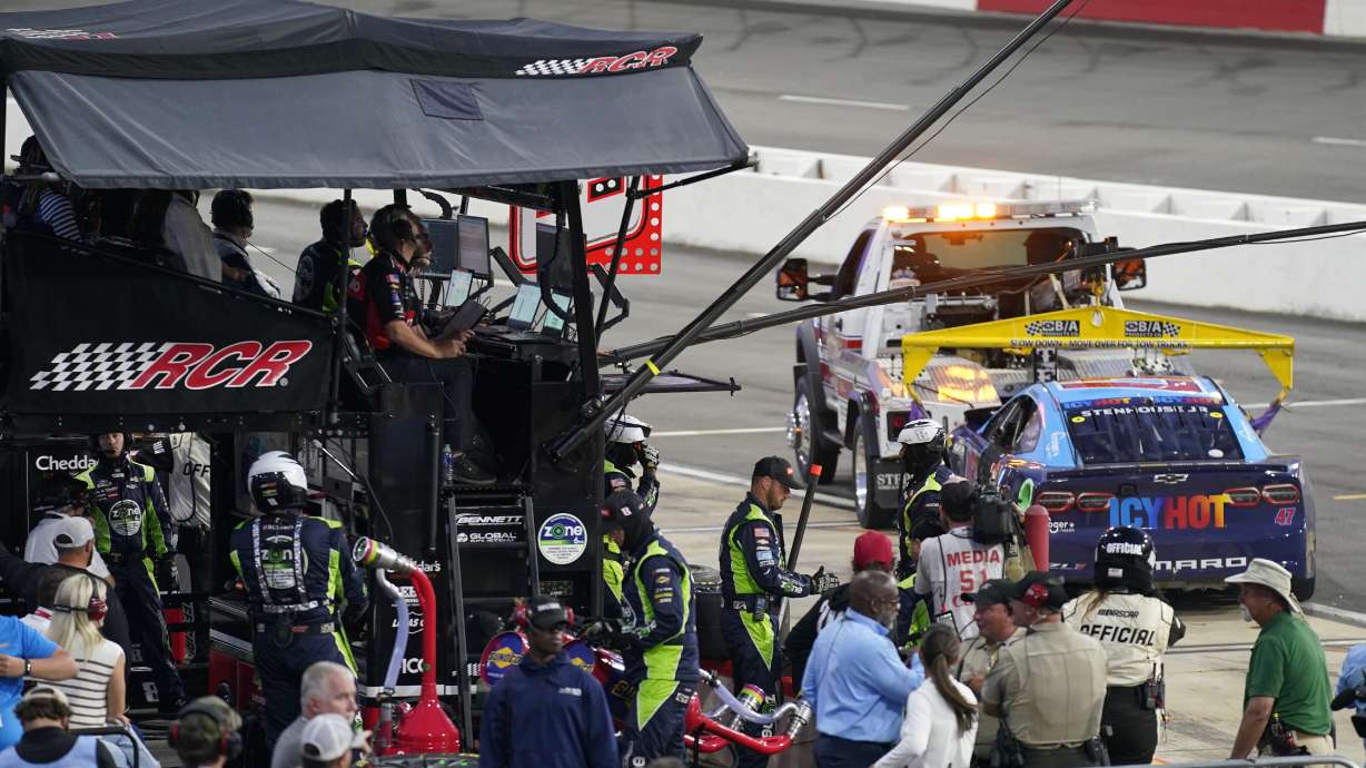The car of Ricky Stenhouse Jr. is towed away from the pit of Kyle Busch during the NASCAR All-Star auto race at North Wilkesboro Speedway in North Wilkesboro, N.C., Sunday, May 19, 2024. Stenhouse crashed after contact with Busch and stopped his damaged car at Busch's team's pit.